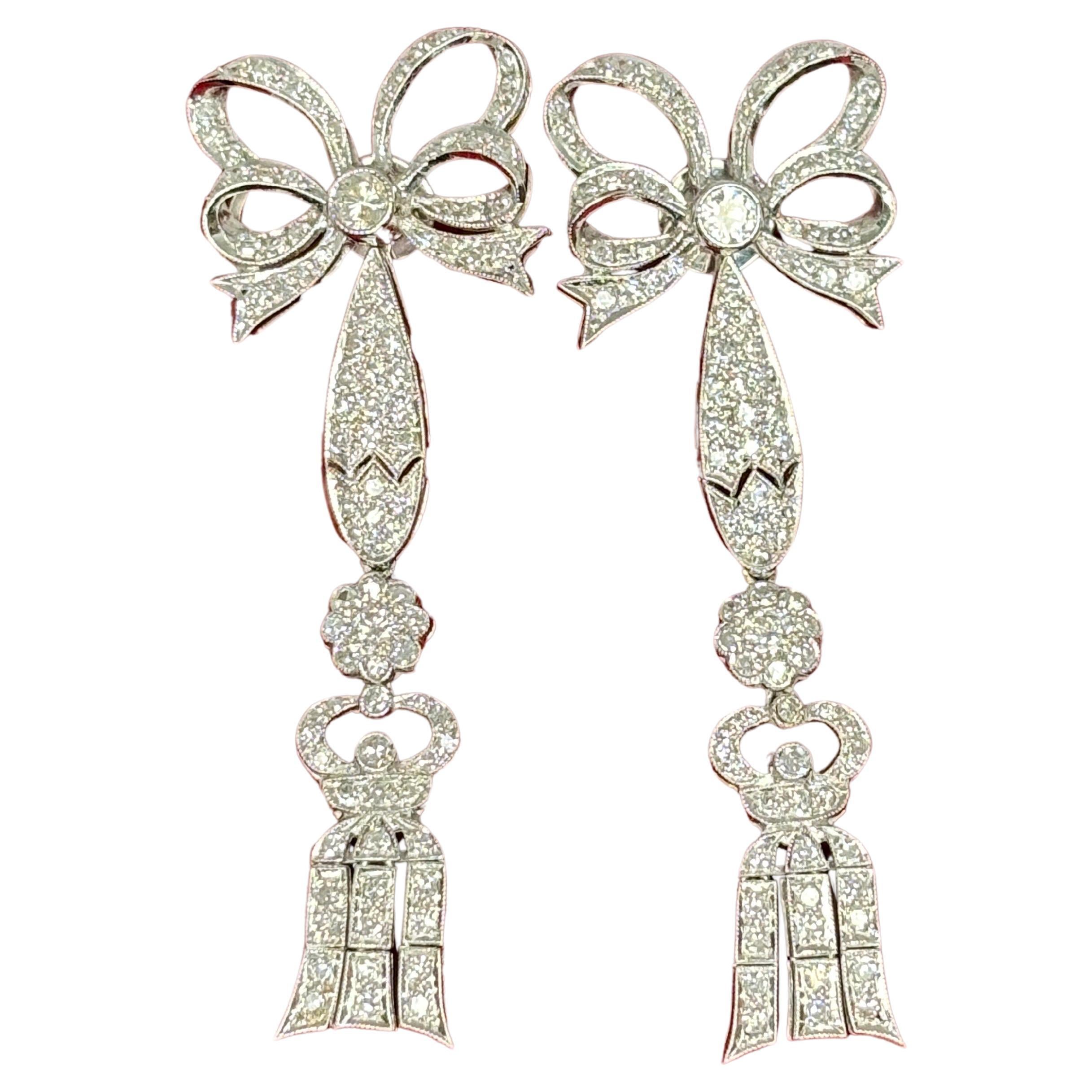 These unique multi-use 18k white gold earrings with diamonds are crafted in a stunning edwardian bow and tassel design and are the epitome of versatility and luxury.

Expertly crafted with round brilliant cut and single cut diamonds, for those who