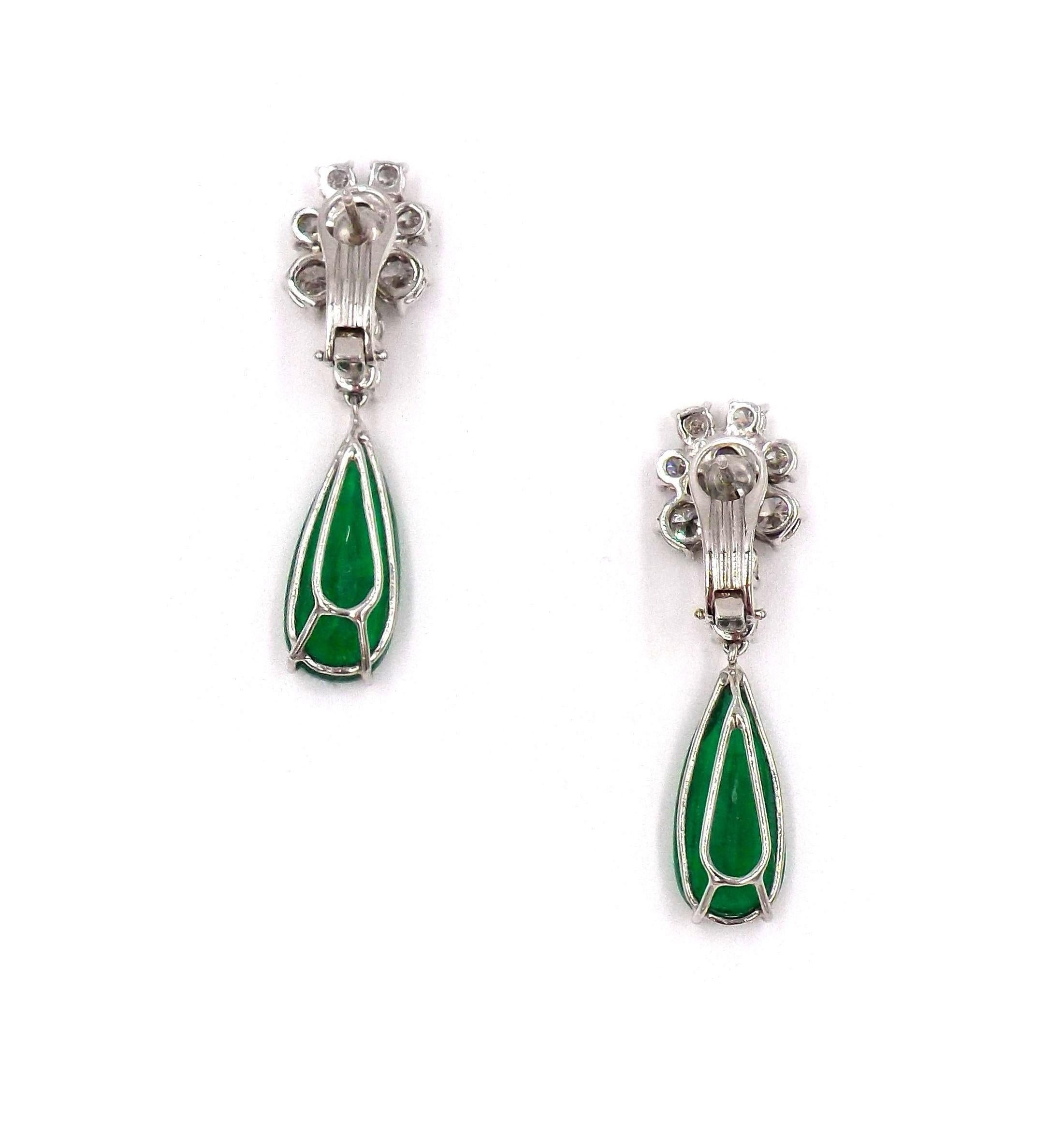 A pair of elegant earrings featuring two pear-shaped emeralds surrounded by diamonds mounted in 18K gold. Emerald weight is approx. 14.16ct. Diamond weight is approx. 4.60ct. Emeralds are accompanied by a Dunaigre certificate stating that the