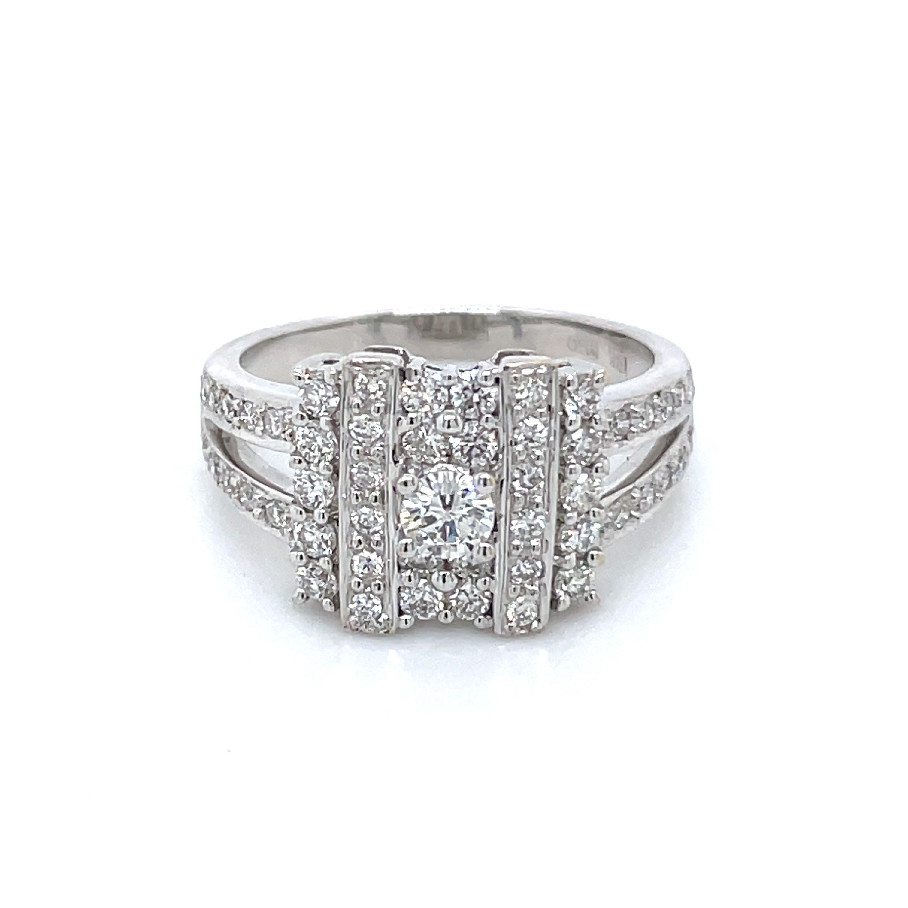 At the heart of this exquisite piece sits a magnificent 0.18-carat round diamond, flanked by two vertical rows of diamonds, creating an enchanting visual appeal. 

This ring features a captivating display of diamonds totaling 0.88 carats, comprising