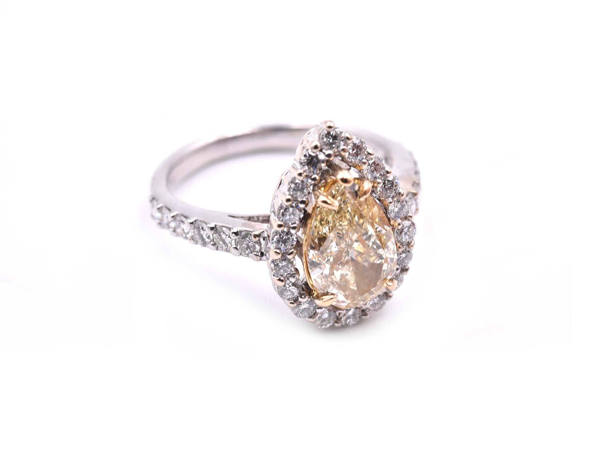Designer: custom design
Material: 18k white gold
Center Diamond: 1 pear cut fancy light yellow= 1.84ct
Color: I
Clarity: SI1
Diamonds: 42 round brilliant cut= .84cttw
Color: G
Clarity: VS
Ring size: 6 ¾ (please allow two additional shipping days for