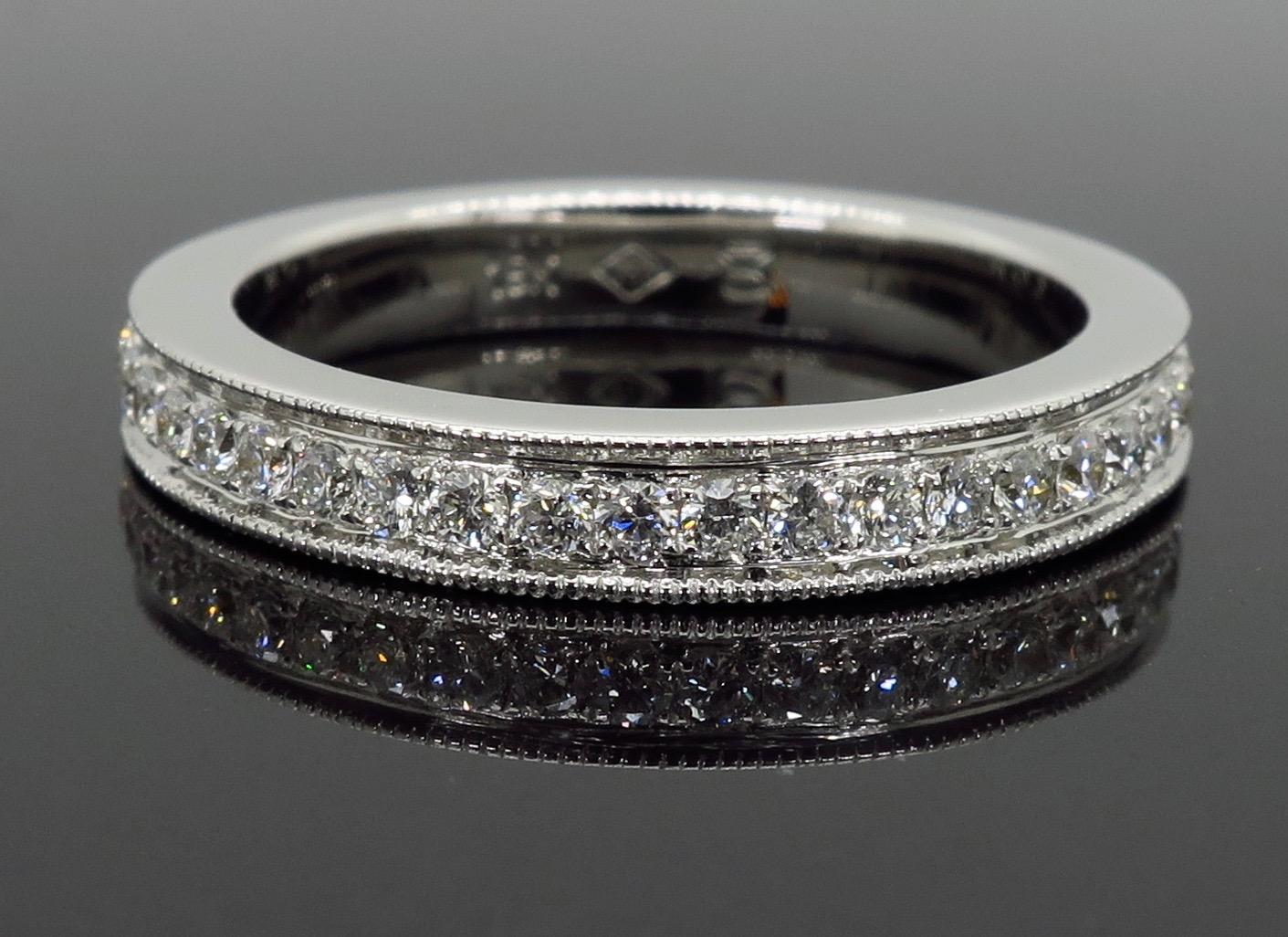 This stunning diamond eternity band is adorned with .82CTW of round brilliant cut diamonds with beautiful mil-grain detail along the 18k white gold channels.

Diamond Carat Weight: .82CTW
Diamond Cut: Round Brilliant Cut Diamonds
Color: Average