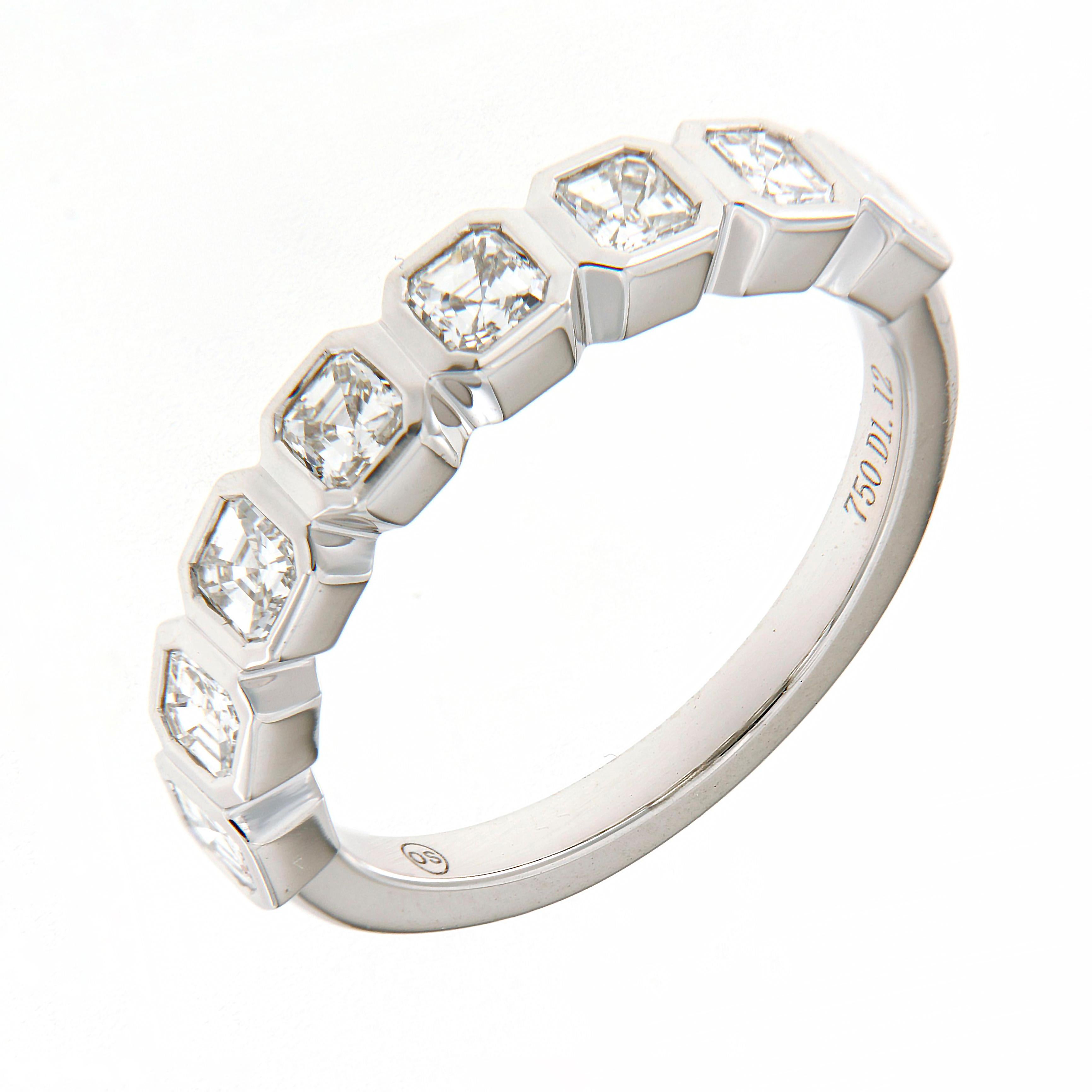 This exquisite 18K White Gold Diamond Fancy Wedding Band showcases timeless sophistication with a modern twist. Designed with a sleek half-way setting, the band features square emerald-cut diamonds in secure bezel mounts, creating a seamless flow of