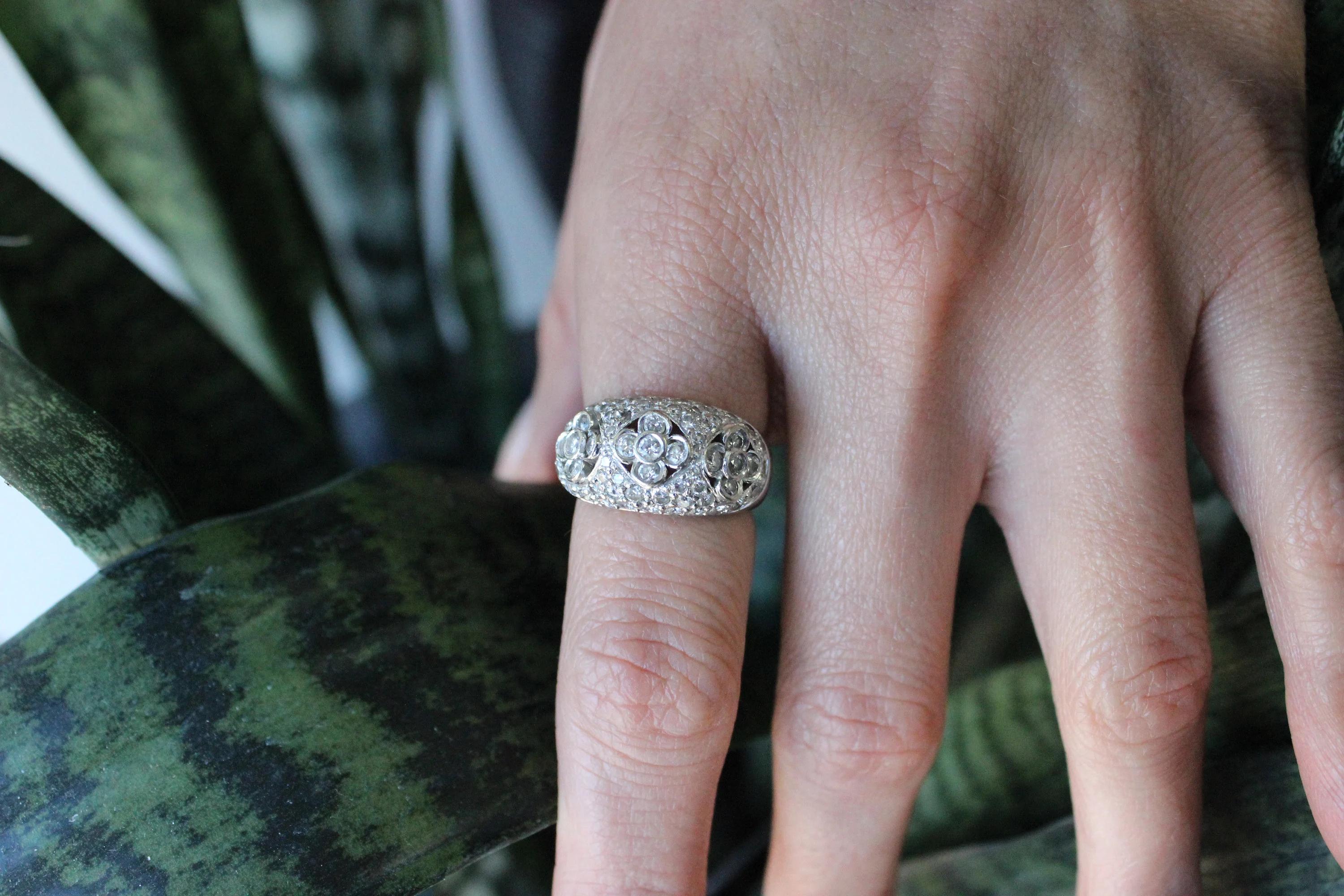This striking and intricate vintage diamond ring features a one-of-a-kind floral design. Crafted in 18k white gold, it is set with approximately 1.64 carats of natural round diamonds, adding a brilliant touch to the unique design.  

Currently a
