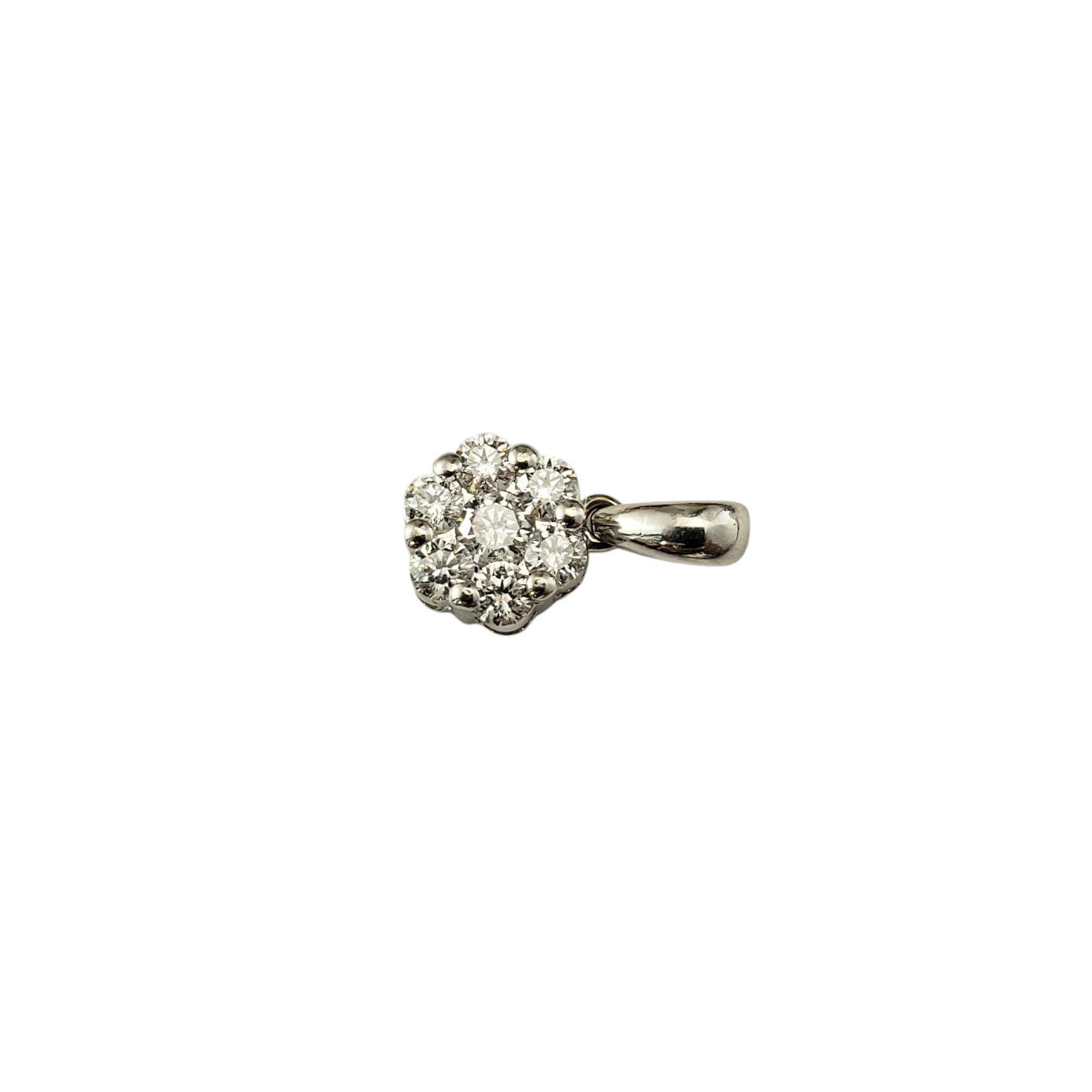 18K White Gold Diamond Flower Pendant-

This sparkling 18K white gold pendant features seven round brilliant cut diamonds arranged in a lovely floral cluster design.

Approximate total diamond weight: .20 - .23 ct.

Diamond color: F

Diamond
