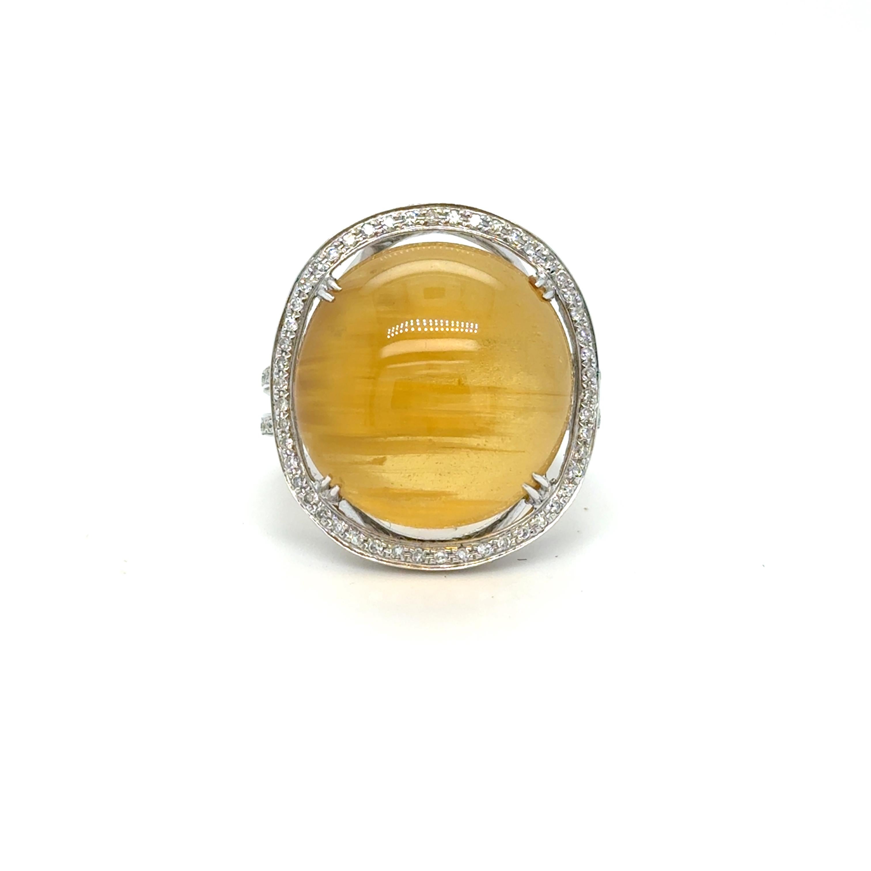 Looking for a super unique, staement ring, with an unusual gemstone and sparkly diamonds? I got you! Crafted in 18K White Gold, this ring features a fabulous Cat's Eye Chrysoberyl center, cut in the Cabochon style, surrounded by a Halo Of Pave Set