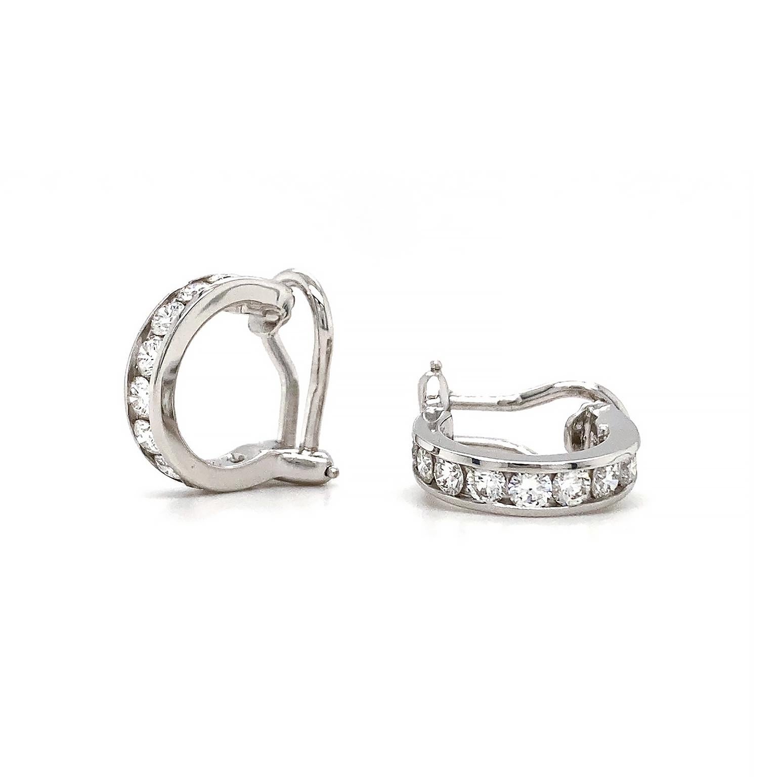 Scintillation from a column of diamonds beam. Set in 18k white gold to further emphasize the jewels, each diamond was carefully chosen for a coherent arrangement of size and color, totaling 1.3 carats. The hoop settings are 3/4 to allow for a