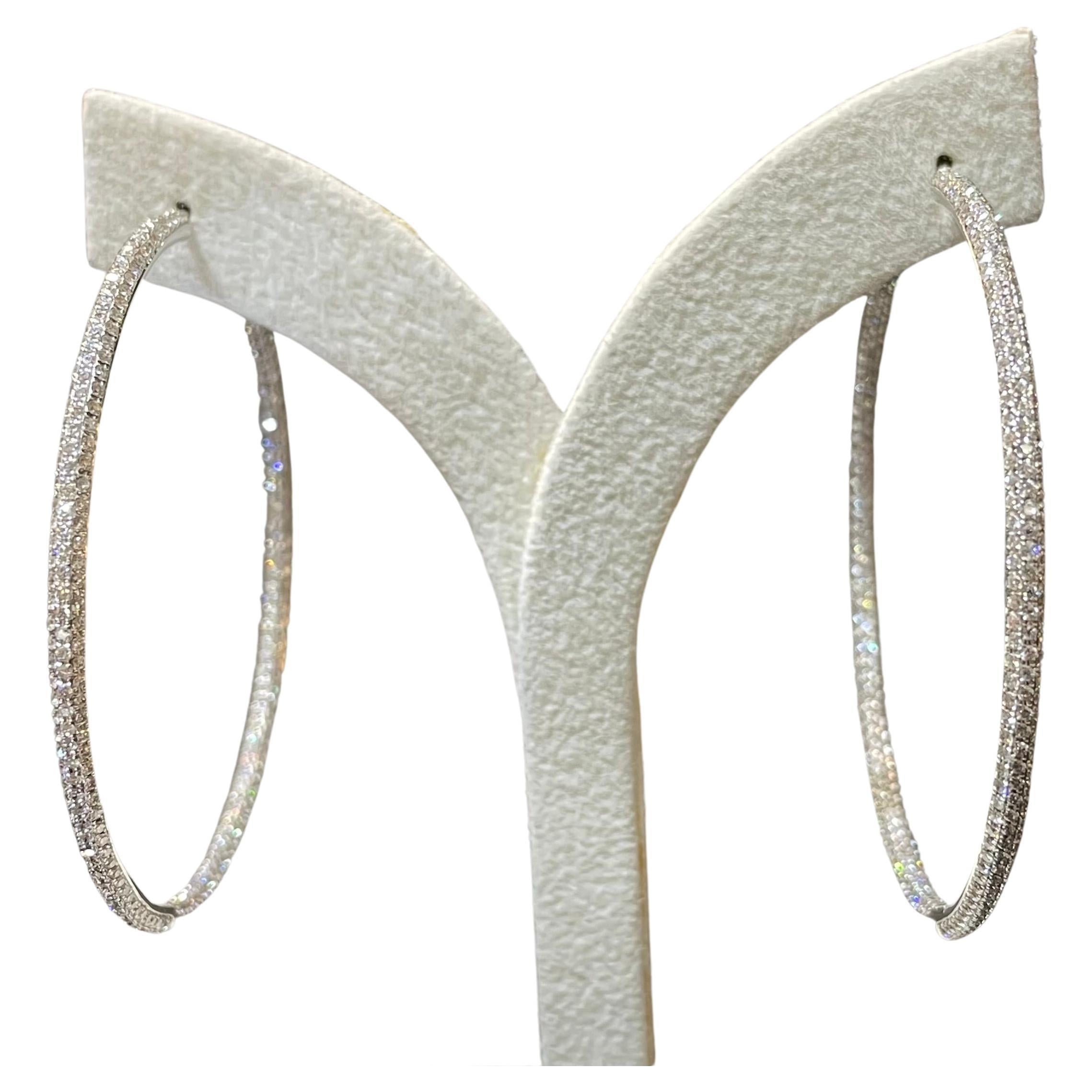  2 inches diameter hoop earrings features round brillant-cut diamonds. Totalling 691 pieces of diamonds, weighing 3.15 carats. Made in 18K white gold. Perfect gift for you and your loved one.