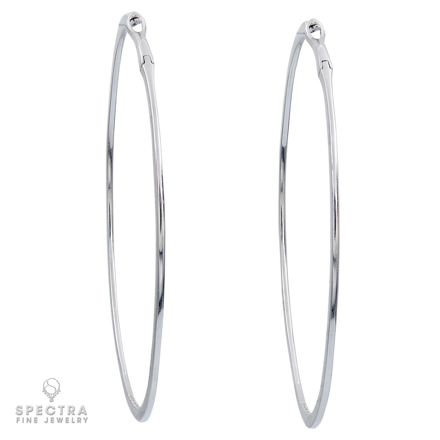 These Contemporary 18k White Gold Diamond Inside-out Hoop Earrings are a stunning addition to any jewelry collection. They are both substantial and comfortable to wear. 
The diamonds are pavé-set half-way around the outside starting at the front