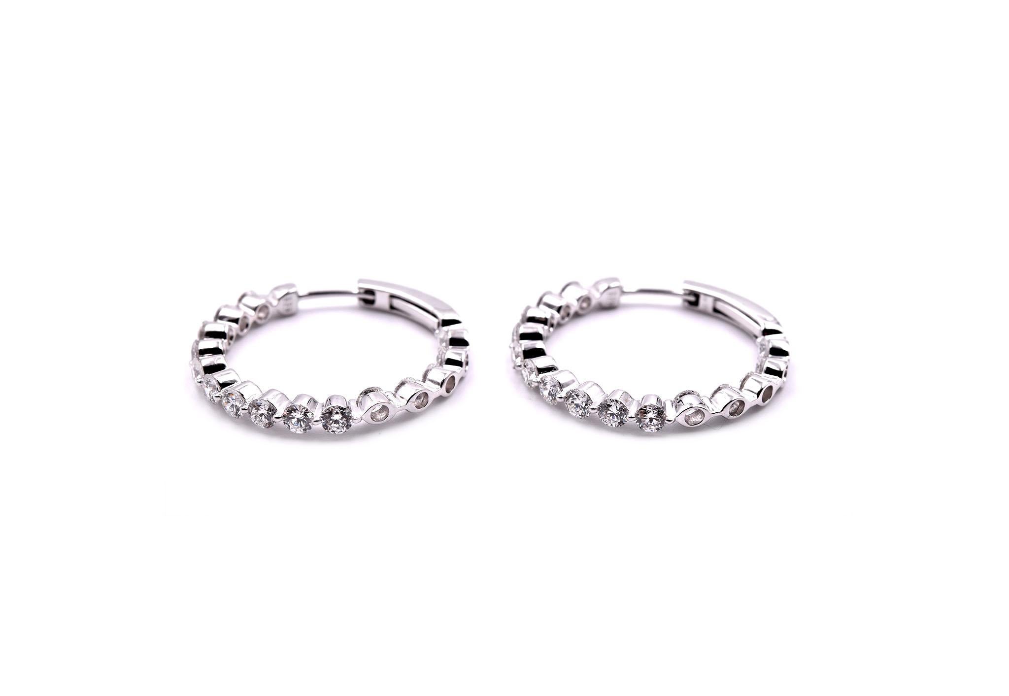 Designer: custom design
Material: 18k white
Diamonds: 30 round brilliant cut = 2.85cttw
Color: G
Clarity: VS
Dimensions: earrings are approximately 28mm in diameter 
Fastenings: hinged hoop 
Weight: 4.10grams