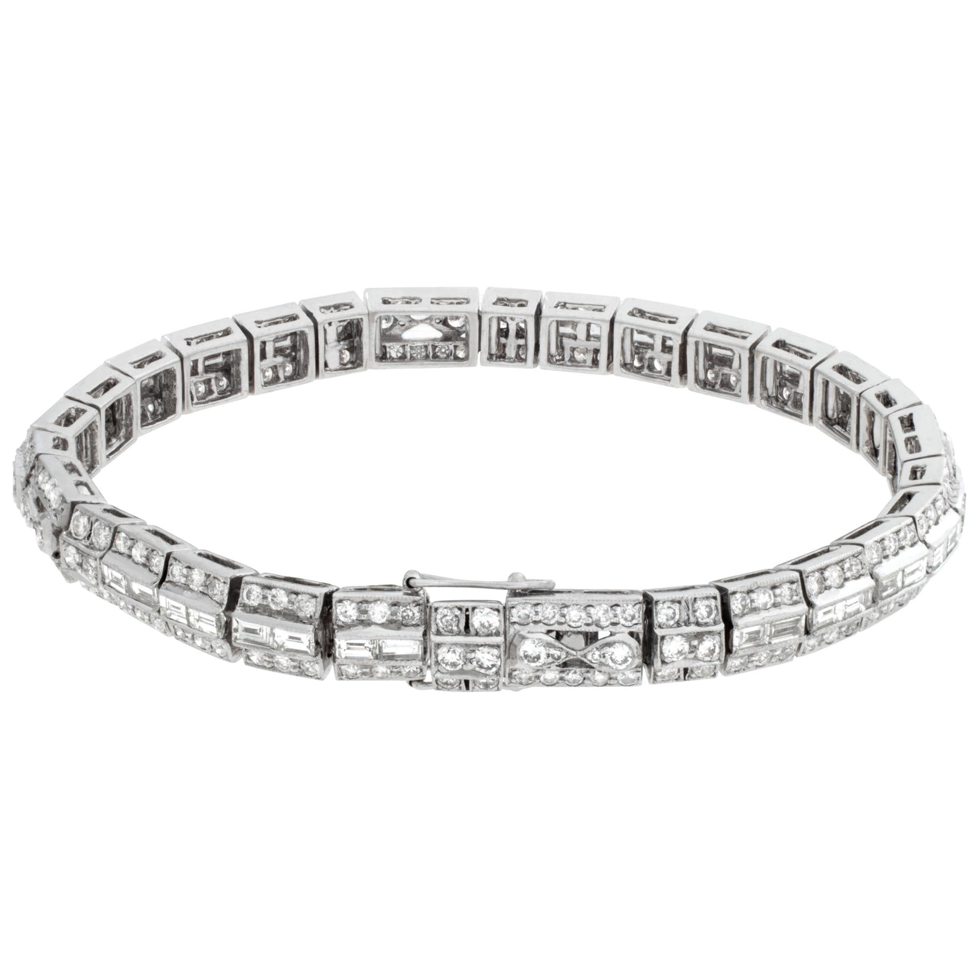 Line bracelet with approx 4.55 carats emerald & round brilliant cut diamonds set in 18k white gold. Diamonds estimate: G-H color VS-SI clarity. Measurements: 6.50 inches long x 0.25 inch wide..
