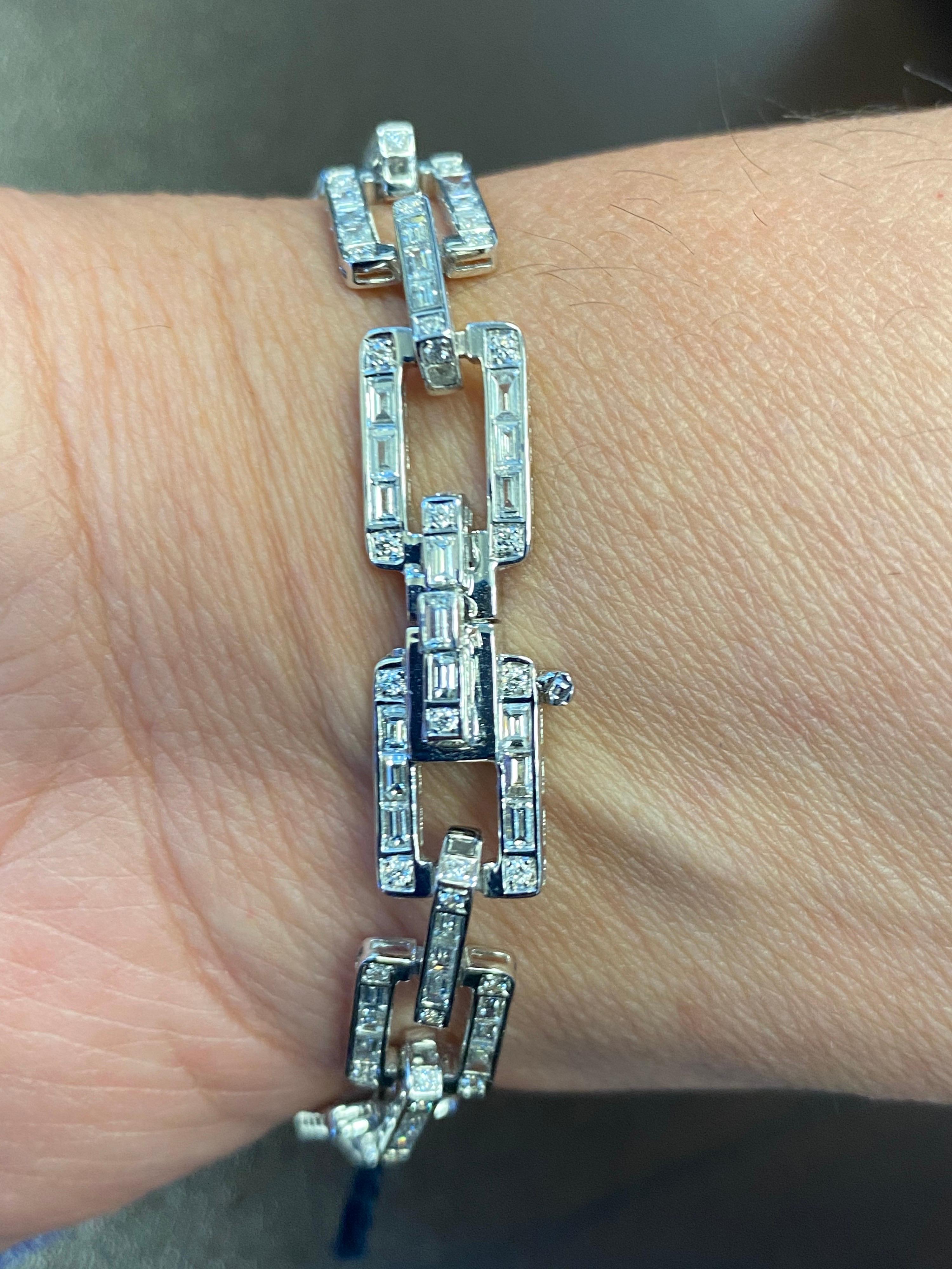 Baguette and round diamonds set in 18K white gold. The diamonds are set in a chain link style. The total diamond weight is 5.07 carats. The color of the stones are F, the clarity is VS1-VS2.