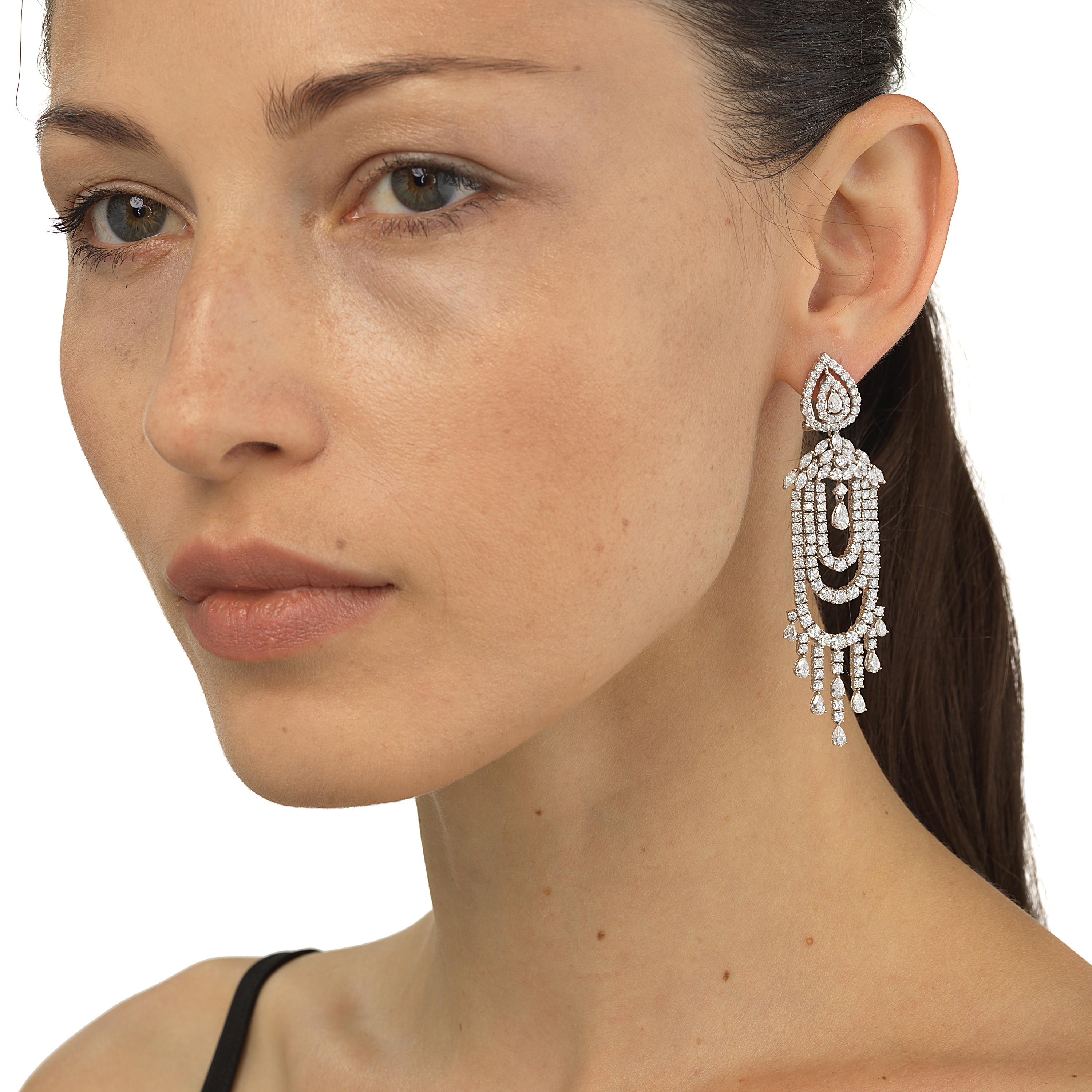 This 18 Karat white gold diamond multi-string chandelier dangle earring is a fashion articulated. Shine in the beauty of diamonds with these amazing dangle earrings. Set in 18 Karat white gold these danglers glimmer with 12.26 Cts of varied shapes