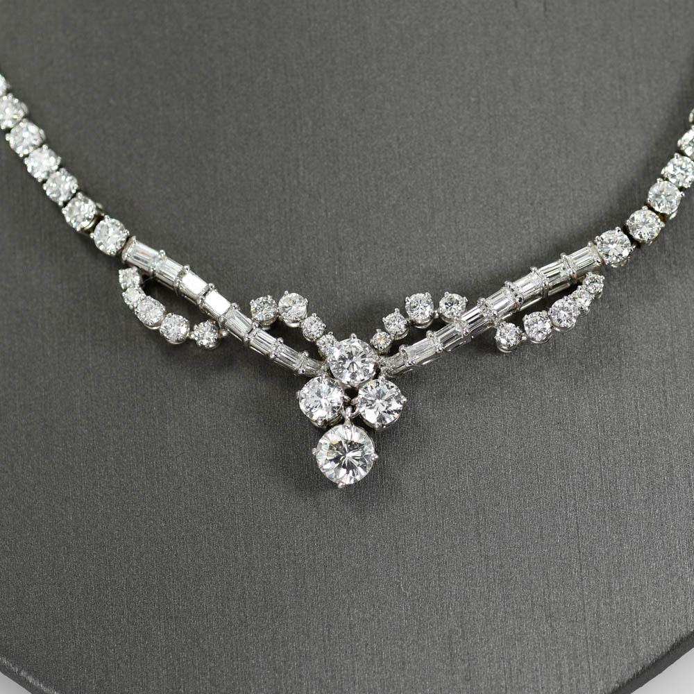 Ladies diamond necklace in 18k white gold setting.
Stamped 18k and weighs 22 grams gross weight.
Most of the diamonds are round brilliant with a few baguette cuts. 
The center diamond is .95 carats, J to k color Si2 clairity.
The other three side