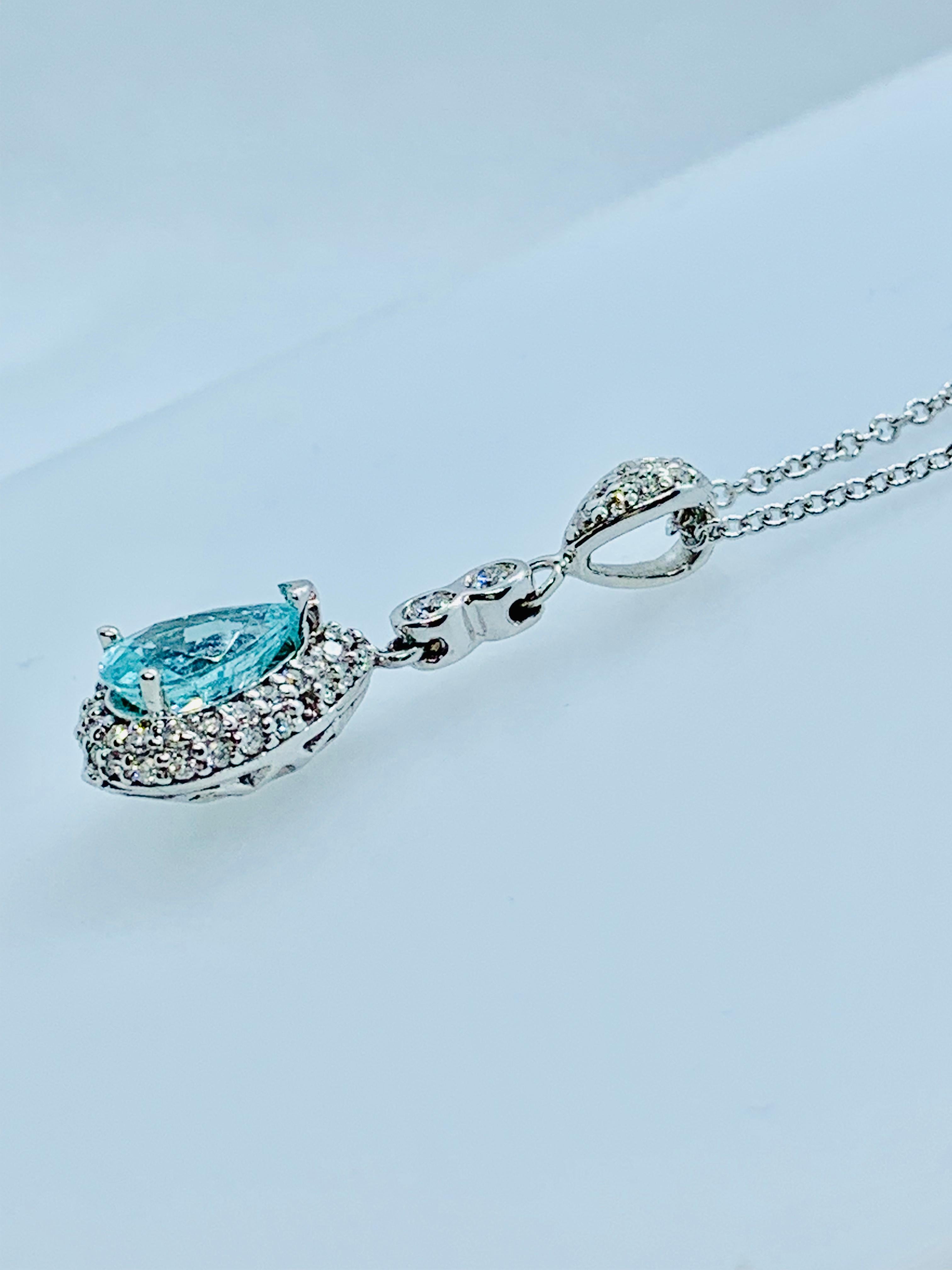 This is a stunning pendant necklace! The Drop pendant is in 18K White Gold and features a gorgeous, pear shaped, 1.26 carat Paraiba Tourmaline. The color of the tourmaline is an intense greenish blue. The pendant also features 53 round, white