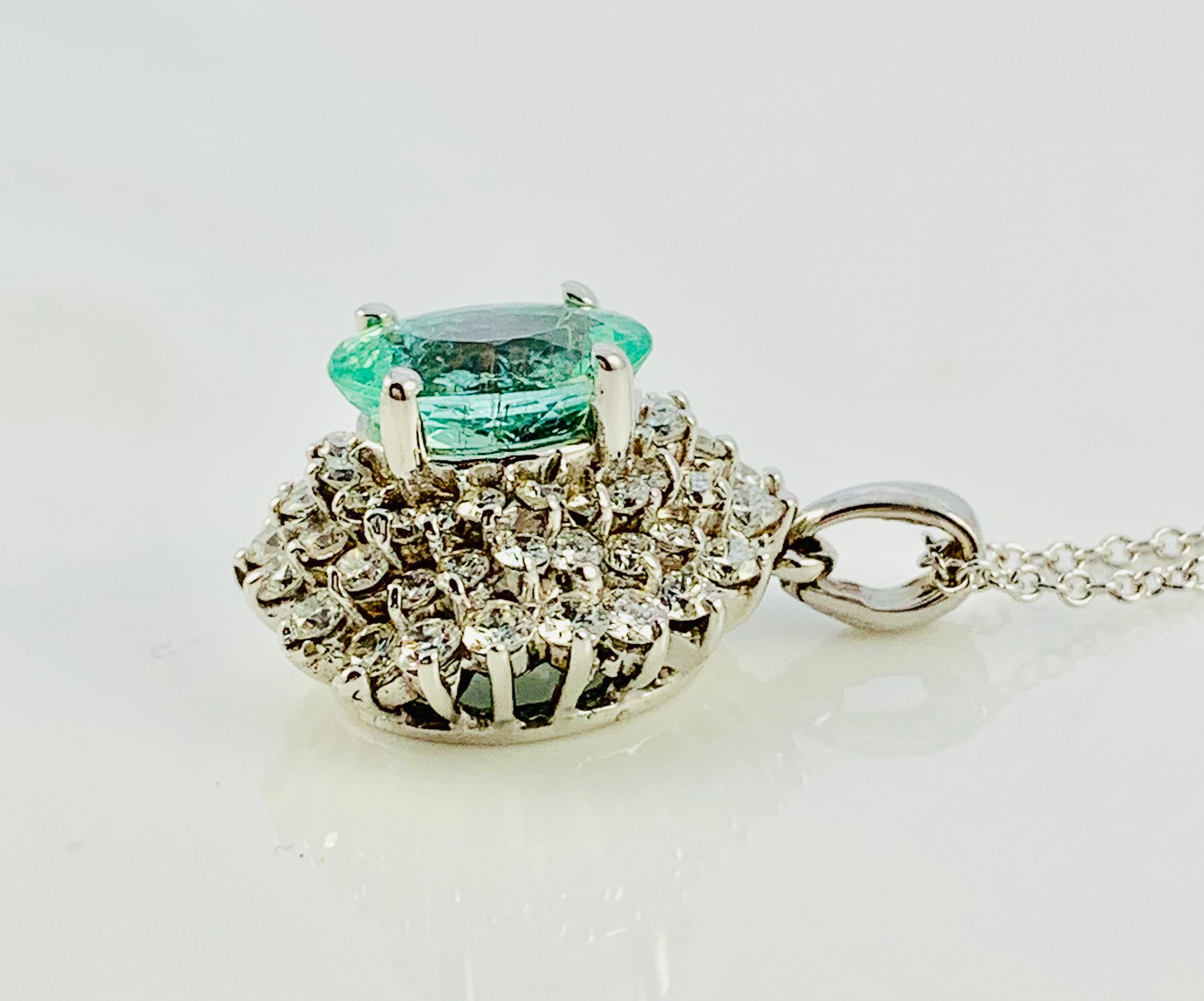 Absolutely Gorgeous Diamond and Paraiba Tourmaline Pendant Necklace. This pendant is made in 18K white gold. At the heart of this piece is a stunning 2.35 Carat Oval Paraiba Tourmaline that its surrounded by three rows of diamonds (20 per row). It