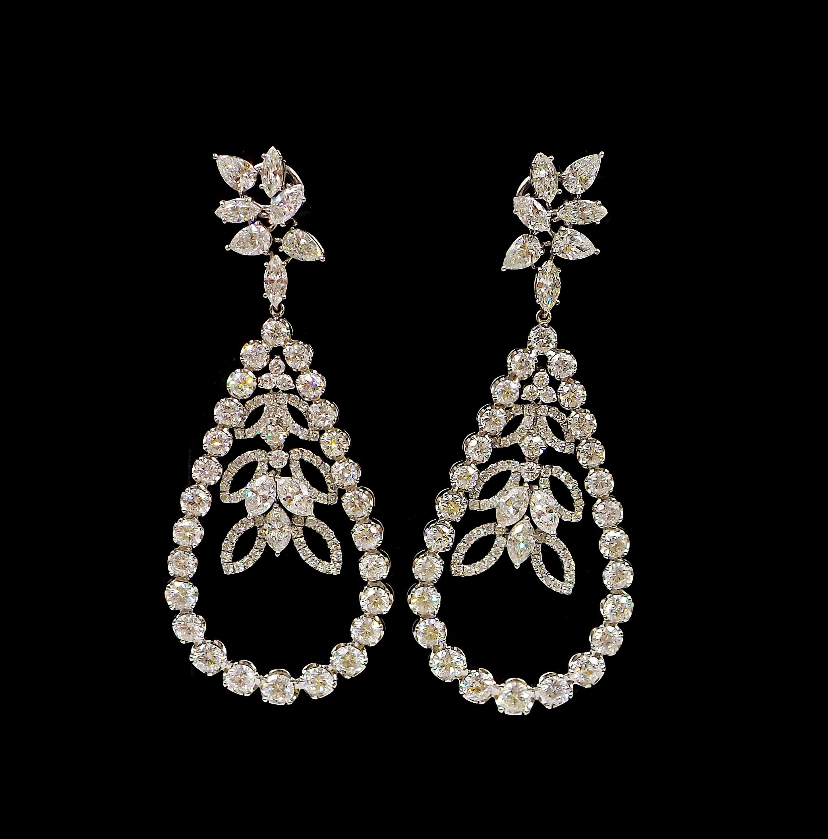 Of teardrop design, each with a central articulated element, set with marquise and round brilliant-cut diamonds; approximate total weight: 16.50 carats; mounted in 18k white gold; length: 3 in.