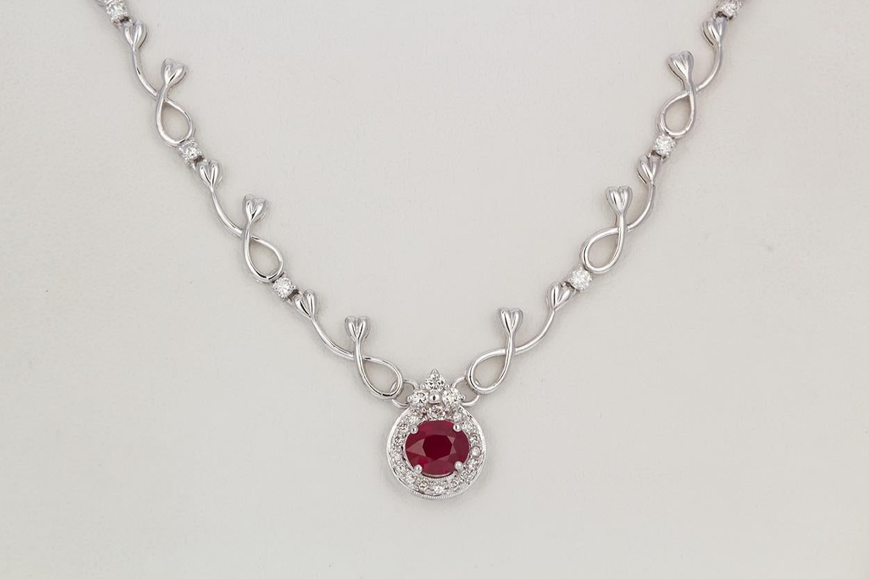 We are pleased to offer this 18k White Gold Diamond & Ruby Necklace. This stunning piece is finely crafted from 18k white gold and features an approximately 1.50ctw round cut ruby, the beautiful deep red ruby is accented by an estimated 1.00ctw