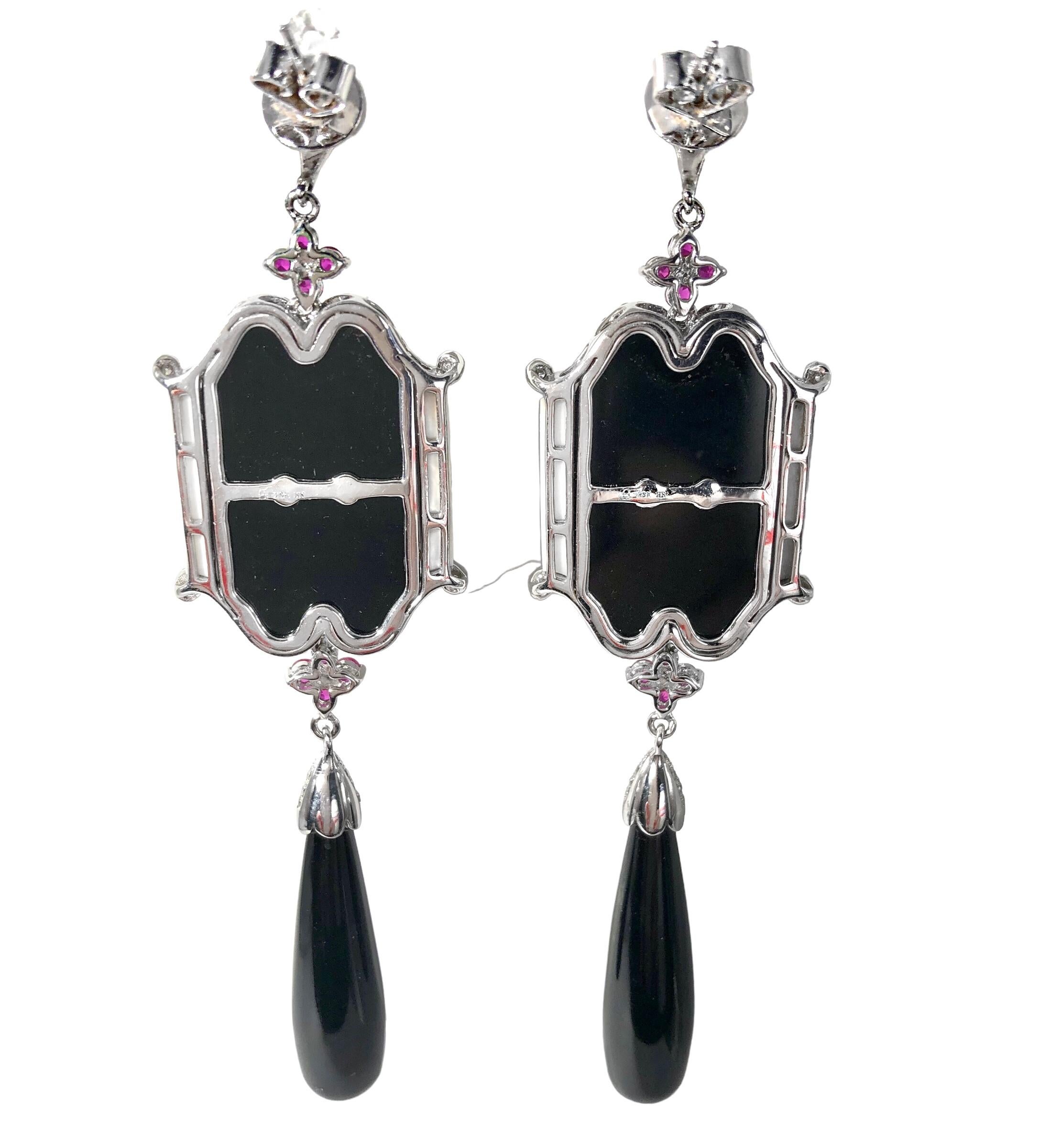 This dramatic and very large pair of Mid-20th Century Classical Victorian style earrings are not only gorgeous but are crafted to the highest standards of quality. Vivid rubies and high quality brilliant cut diamonds are set in all sections of the