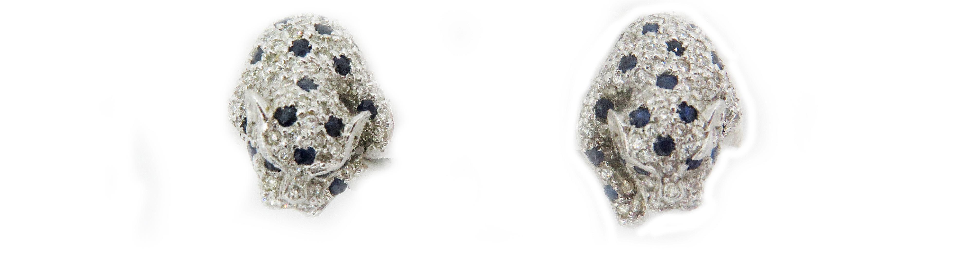 A beautiful, pair of stud panther earrings. Crafted in 18k white gold this beautiful earrings feature lever back. These, beautiful panther earrings are showered all around with beautiful pave diamonds and sapphires.  They weigh, 12.63grams. These,