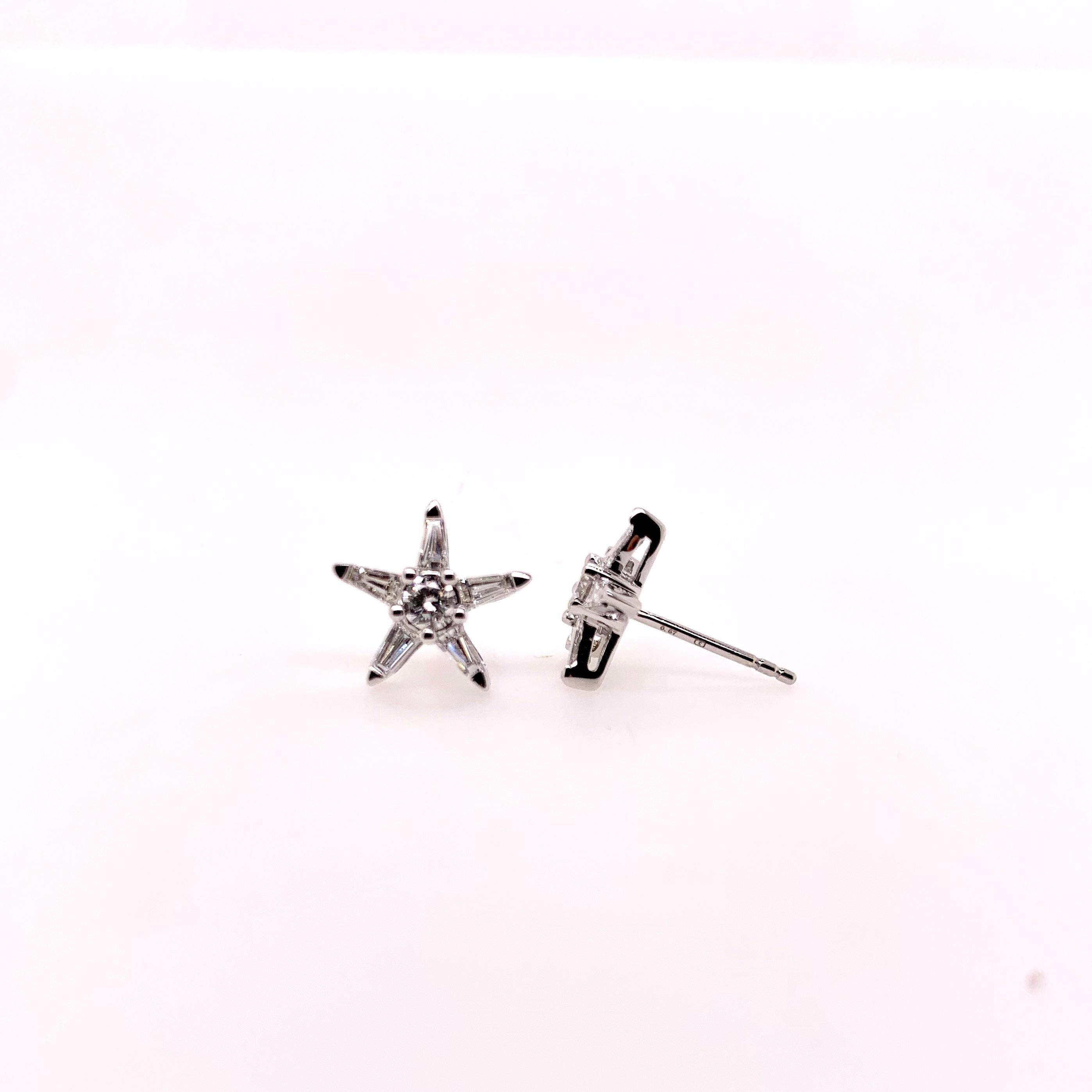 A whimsical pair of diamond star shaped earring studs!   Easy to wear with any outfit and will garnish attention!   Set in 18k white gold, the tapered baguettes form the pointed star and the round brilliant in the center as the focal