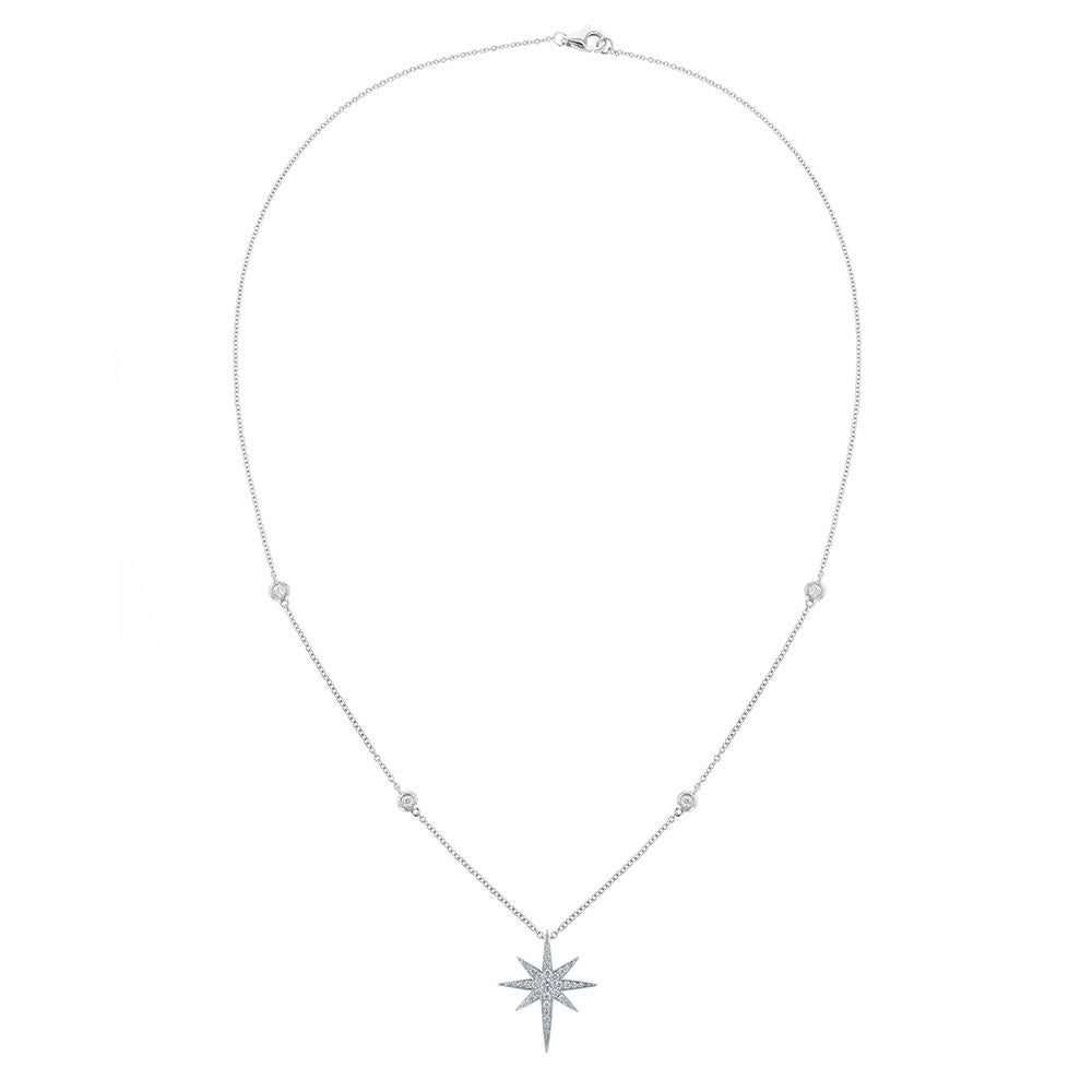 This necklace is made in 18K white gold and features a starburst pendant of 32 round cut, prong set diamonds. With 4 diamond bezel stations on the chain.  Necklace has a color grade (H) and clarity grade (SI1).  With a total carat weight of 0.52ct.
