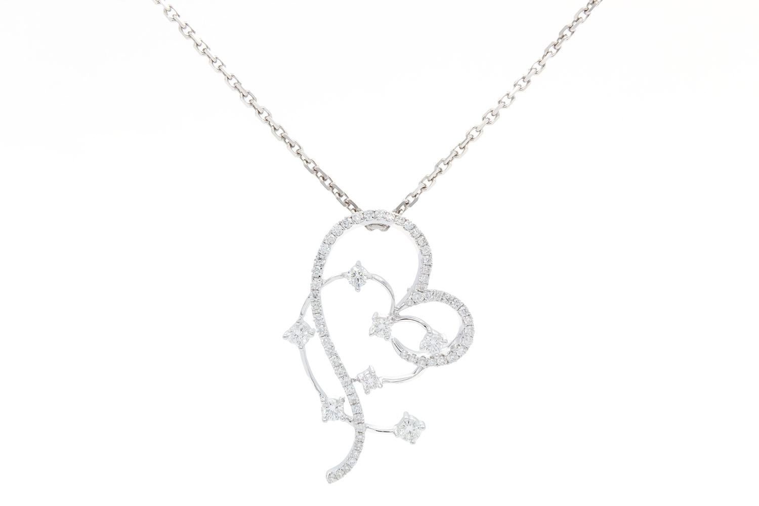 We are pleased to offer this 18k White Gold & Diamond Sweeping Heart Silhouette Pendant Necklace. A timeless pendant crafted from dazzling round diamonds, celebrating the exquisite silhouette of your love. This is stunning 18k white gold pendant is