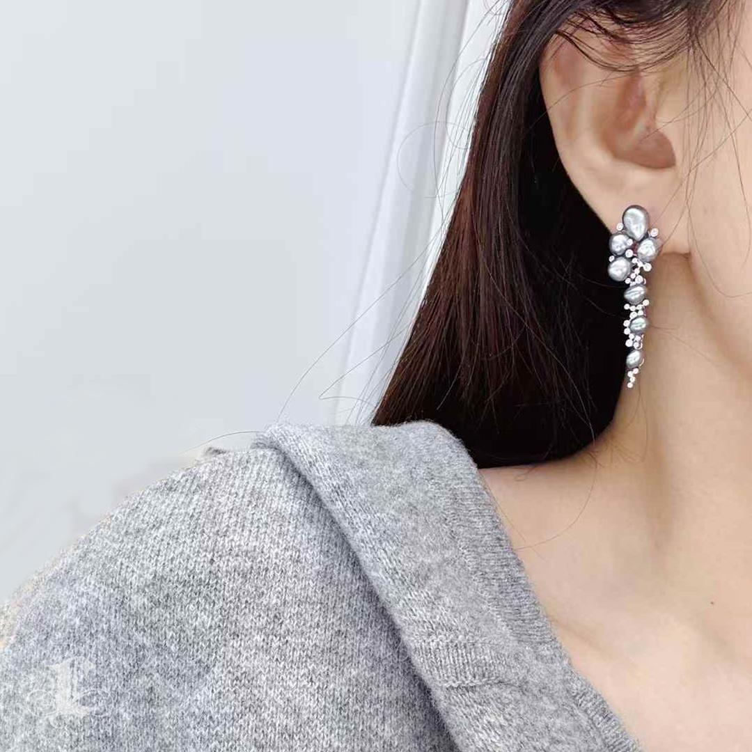 Exuding an ethereal radiance, these Tahitian Keshi Pearl Cluster Earrings captivate with their lustrous, aurora-like sheen. Each naturally shaped, non-nucleated Keshi pearl is carefully selected for its silky smooth texture and mesmerizing gray