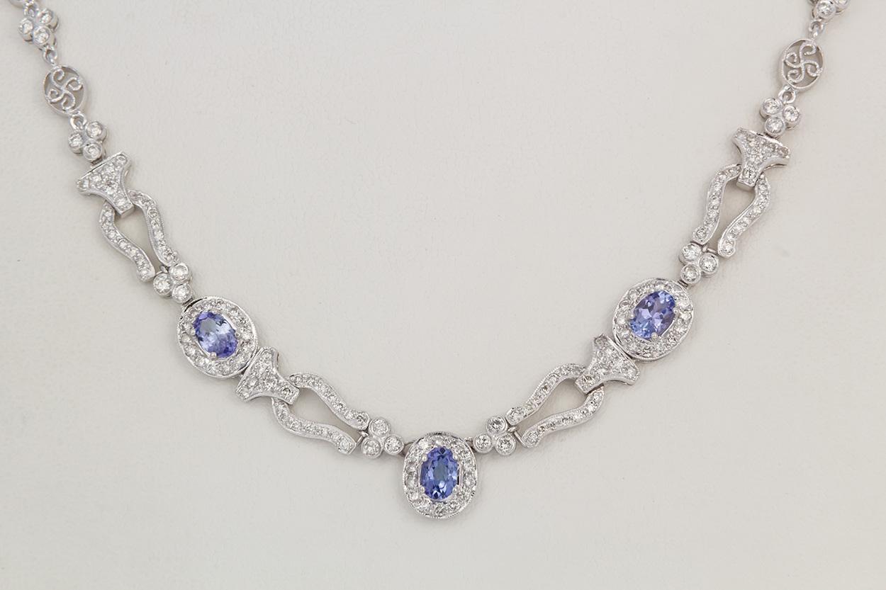We are pleased to offer this 18k White Gold Diamond & Tanzanite Necklace. This stunning piece is finely crafted from 18k white gold and features an approximately 1.50ctw oval cut Tanzanite accented by an estimated 2.30ctw G-H/VS-SI Round Brilliant