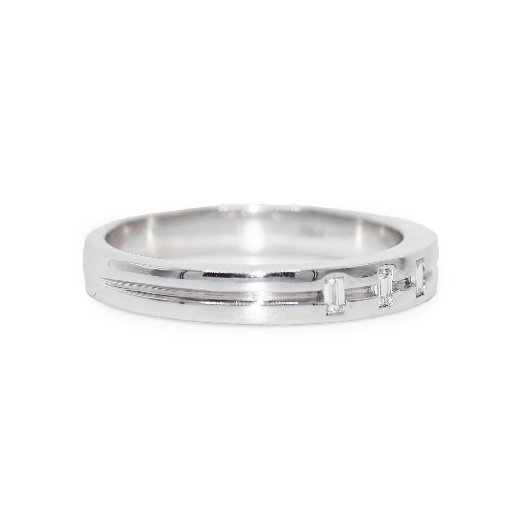 Men's 18k white gold wedding band with diamonds.
Stamped 750 and weighs 7.2 grams.
The diamonds are baguette cuts, G color, Vs clarity, .15 total carats.
The band measures 3.7mm wide.
Ring size is 10 3/4 and can be sized up to 11 1/4 or down to a