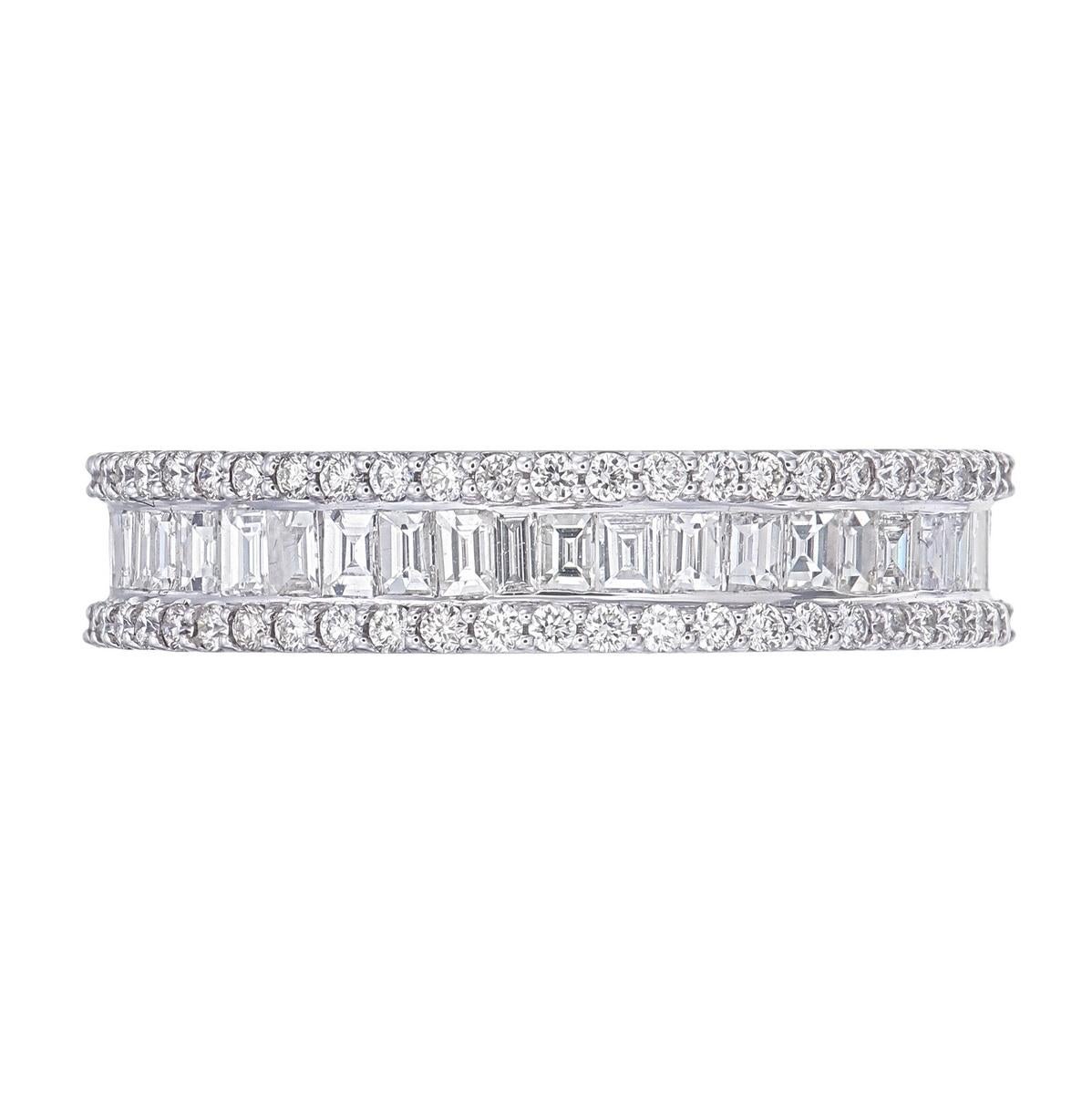 Exquisitely crafted in 18 karat white gold, this timeless eternity band showcases 3.00 carats of natural diamonds. A striking row of baguette-cut diamonds is channel-set at the center, framed on either side by round brilliant-cut diamonds in a