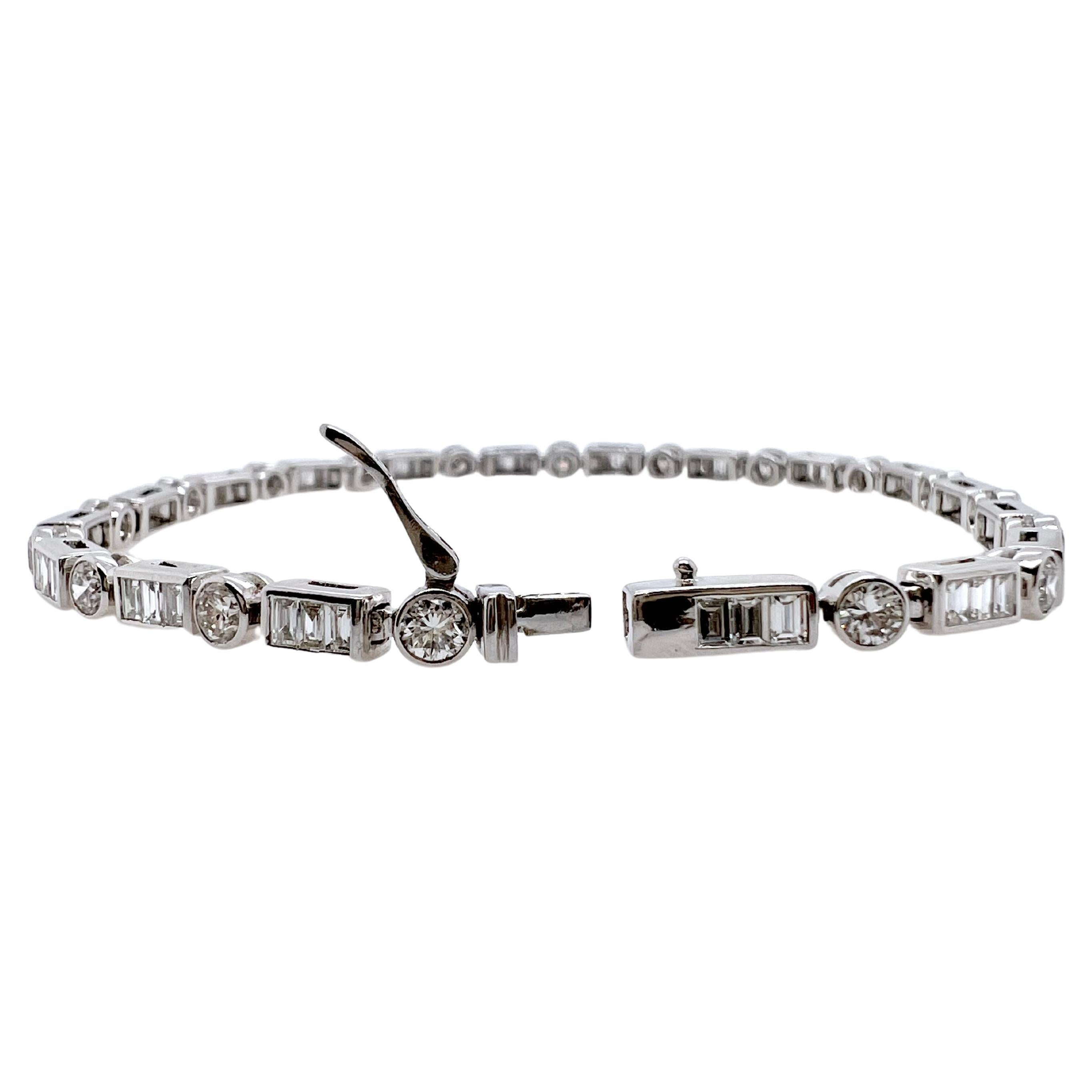 This modern diamond tennis bracelet is so versatile that can be worn smart casual or daily.  It is in 18k white gold and has round brilliant diamonds bezel set along with baguette diamonds channel set.  The pattern makes it different than the