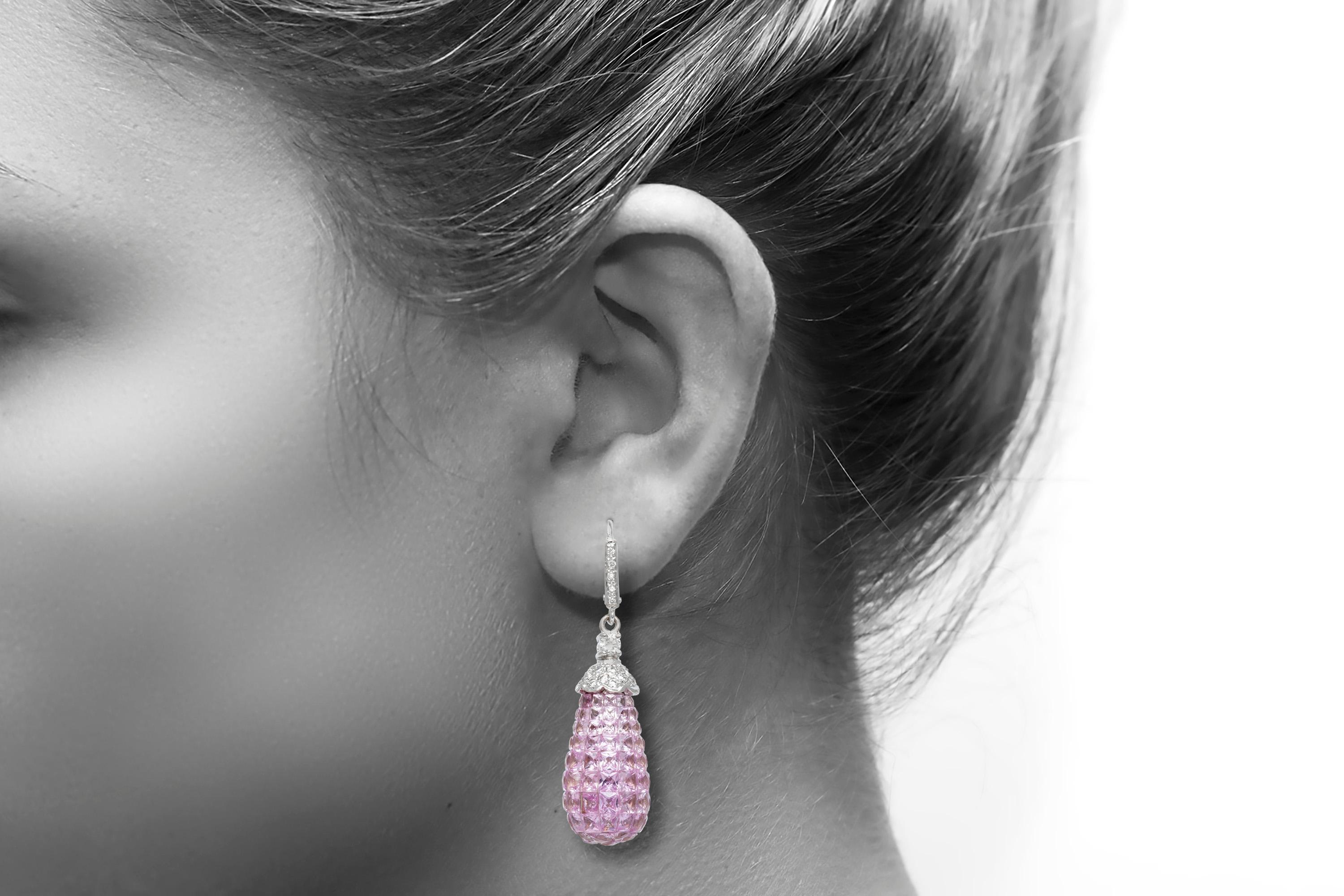 The earrings is finely crafted in 18k whute gold with diamonds weighing approximately total of 0.95 and pink sapphire weighing approximately total of 21.86.
