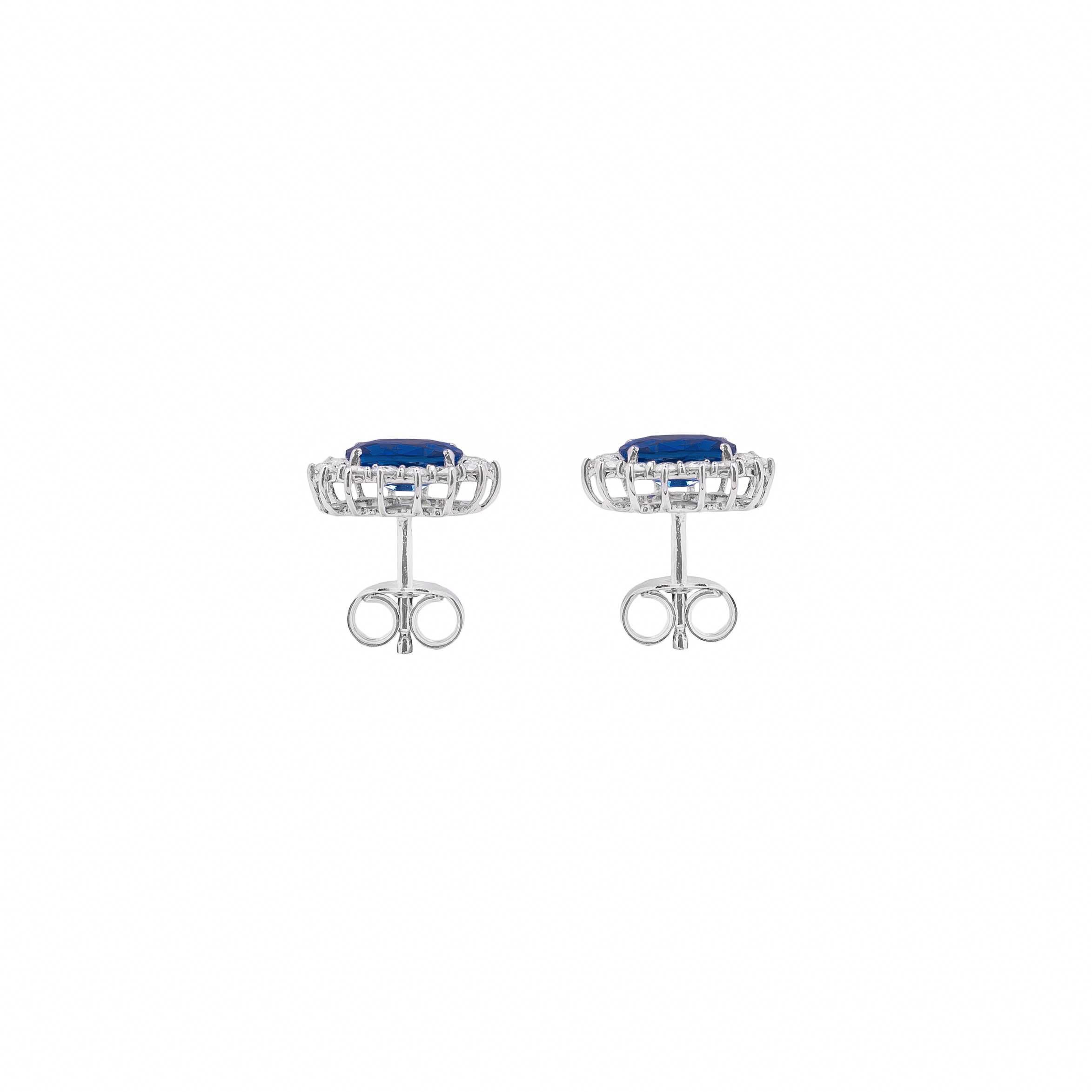 These bright 18K white gold earrings are made in Italy by LeLune.
They feature a stud closure and each earrings consist of one marquise cut blue sapphire in the centre surrounded by a row of smaller brilliant cut  white diamonds.

Sapphires 1.9ct