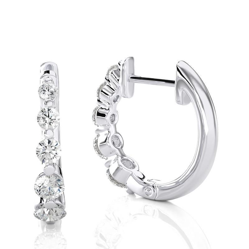 Elevate your jewelry collection with our 18K White Gold Diamonds Huggie Earrings, featuring a total of 0.43 carats and adorned with ten exquisite diamonds. These huggie earrings combine classic elegance with a touch of contemporary flair.

Crafted