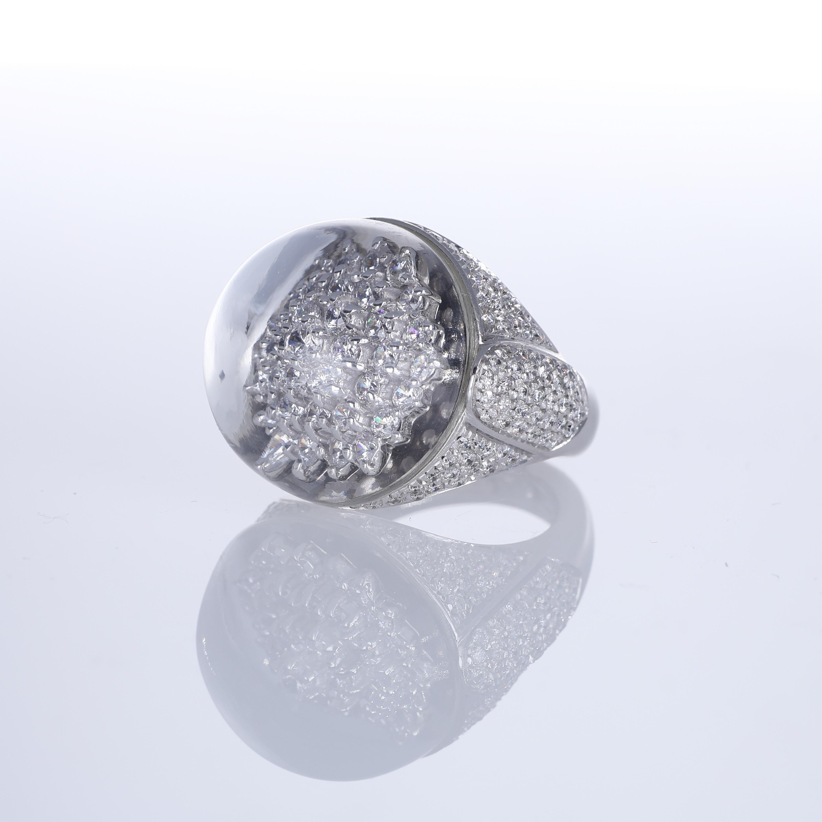 A striking dome-shaped ring in 18K white gold, featuring an intricate snowflake motif set beneath a smooth rock crystal dome. The pavé-set brilliant-cut diamonds create a dazzling effect, magnified by the crystal cover for added brilliance and