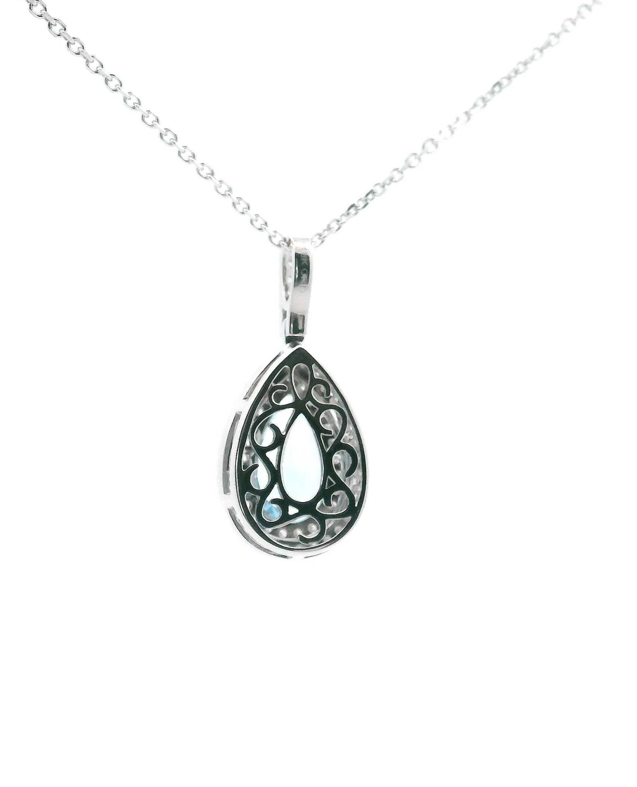 18K white gold double halo necklace furnished with round faceted diamonds weighing 0.38 carat total and one pear shaped aquamarine weighing 1.55 carats. 

- Diamonds are G/H color, VS clarity.
- Lobster lock closure
- Can be worn 16 or 18 inches