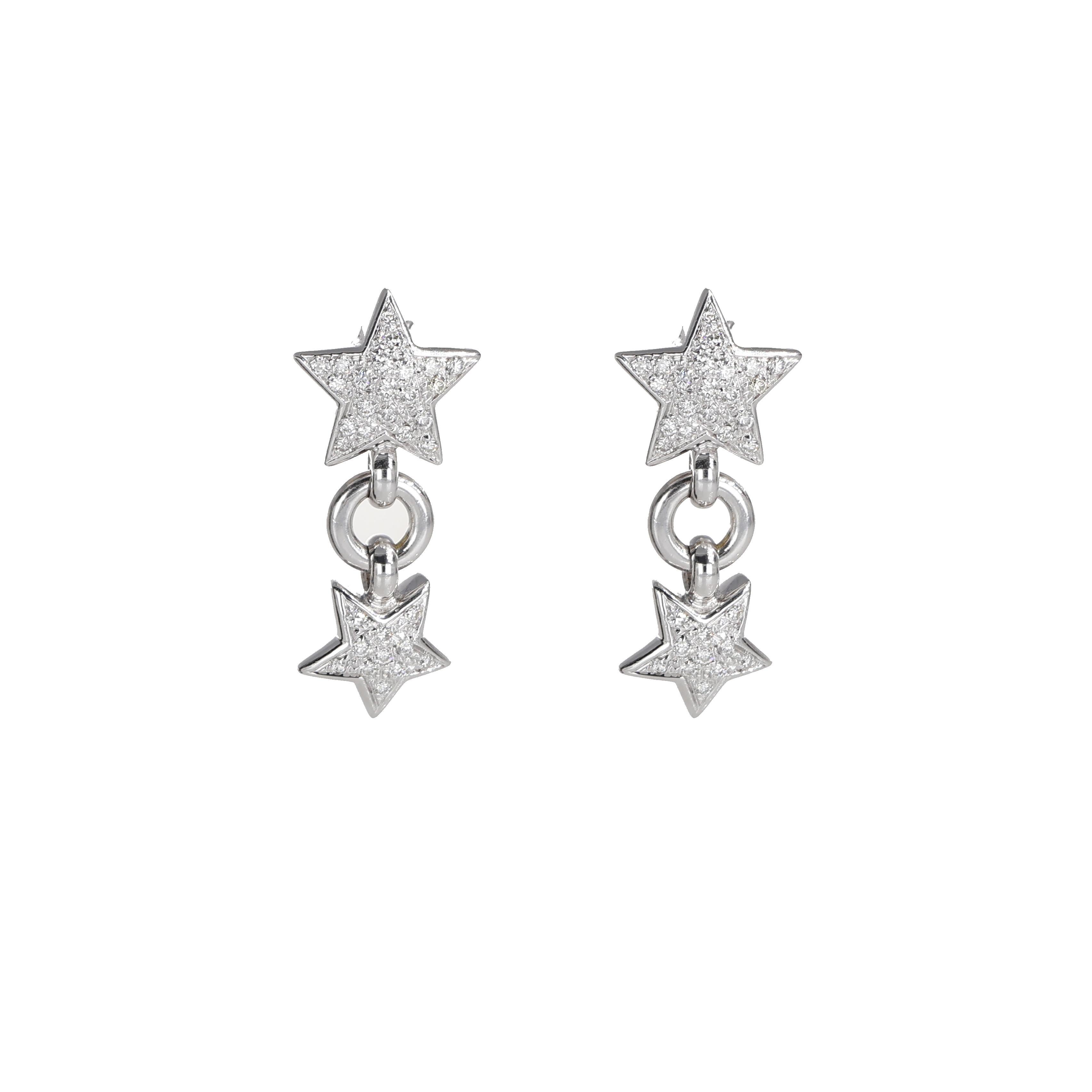 A playful yet elegant pair of drop earrings crafted in 18K white gold, featuring two sparkling star motifs connected by a delicate link. Each star is adorned with a pavé of brilliant-cut diamonds, totaling 0.98 carats, creating a dazzling effect.