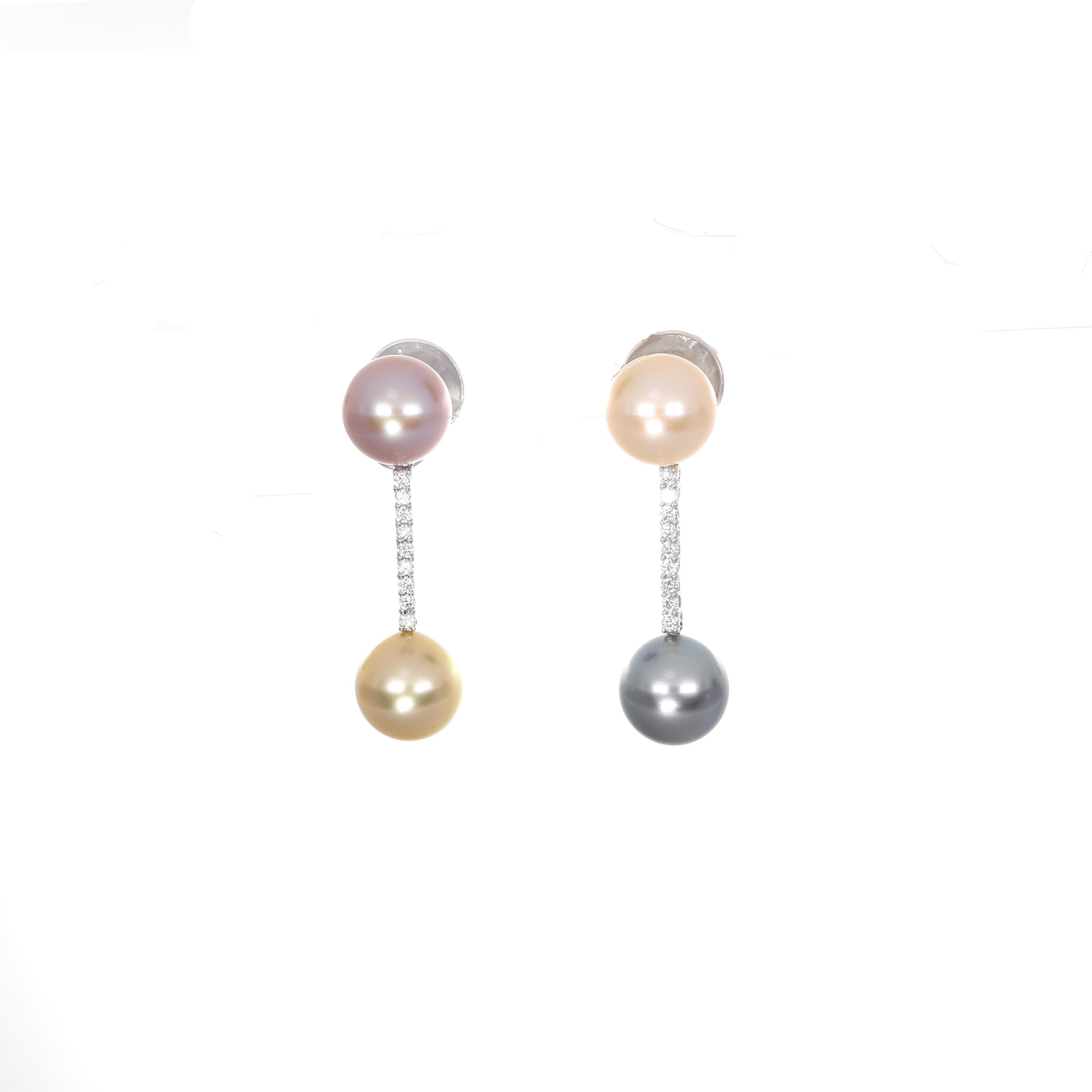 Elegant and contemporary, these 18K white gold drop earrings feature a delicate diamond bar (0.29 carats total) connecting two natural pearls in varying hues. A refined balance of sophistication and modern design, perfect for any occasion.

Key