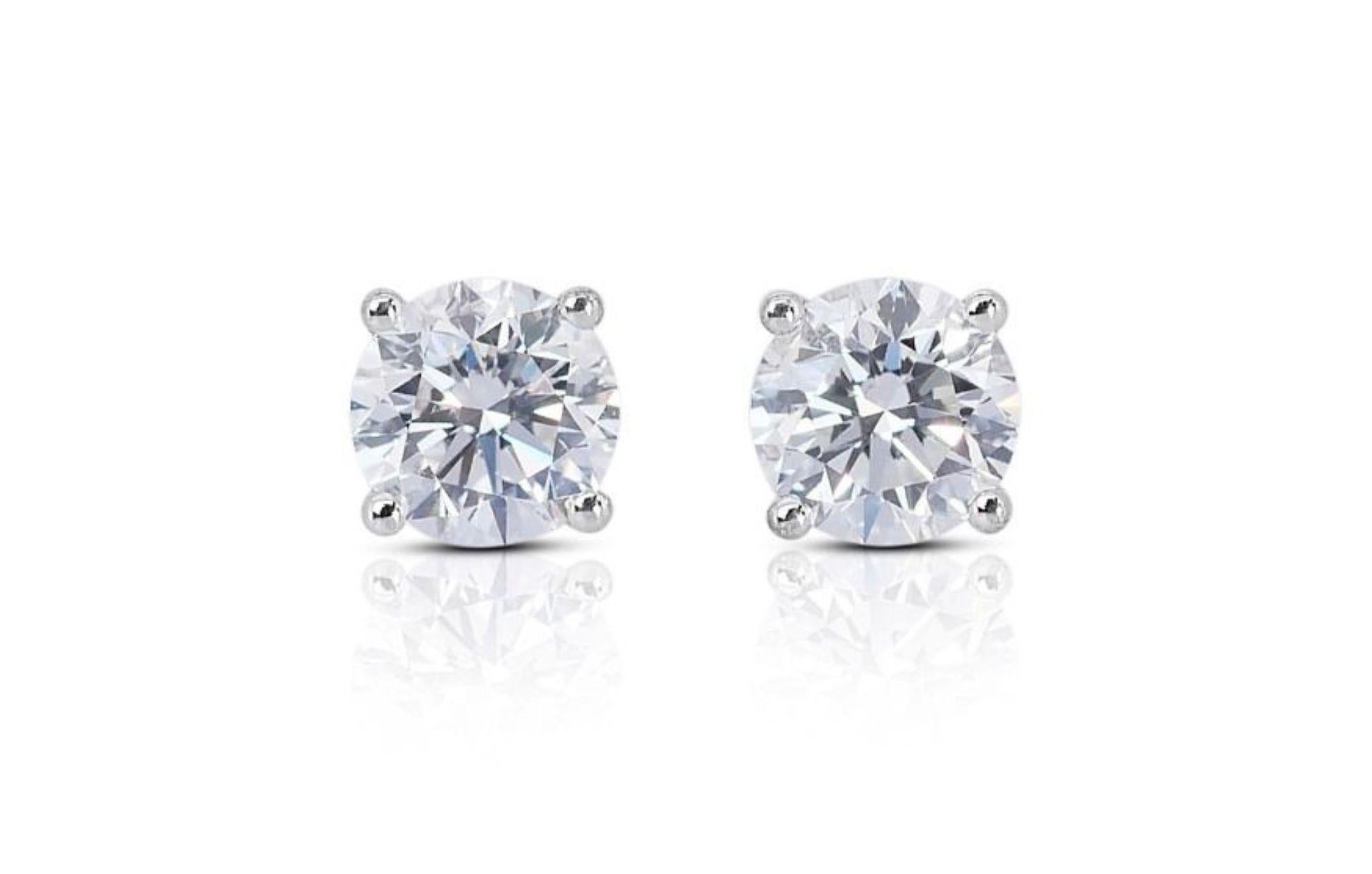 The exquisite earrings are crafted from gleaming 18K White Gold and exude elegance and refinement. The diamonds boast an exceptional D-E color and VVS1 clarity, ensuring a captivating sparkle that radiates timeless glamour. The EX cut grade further