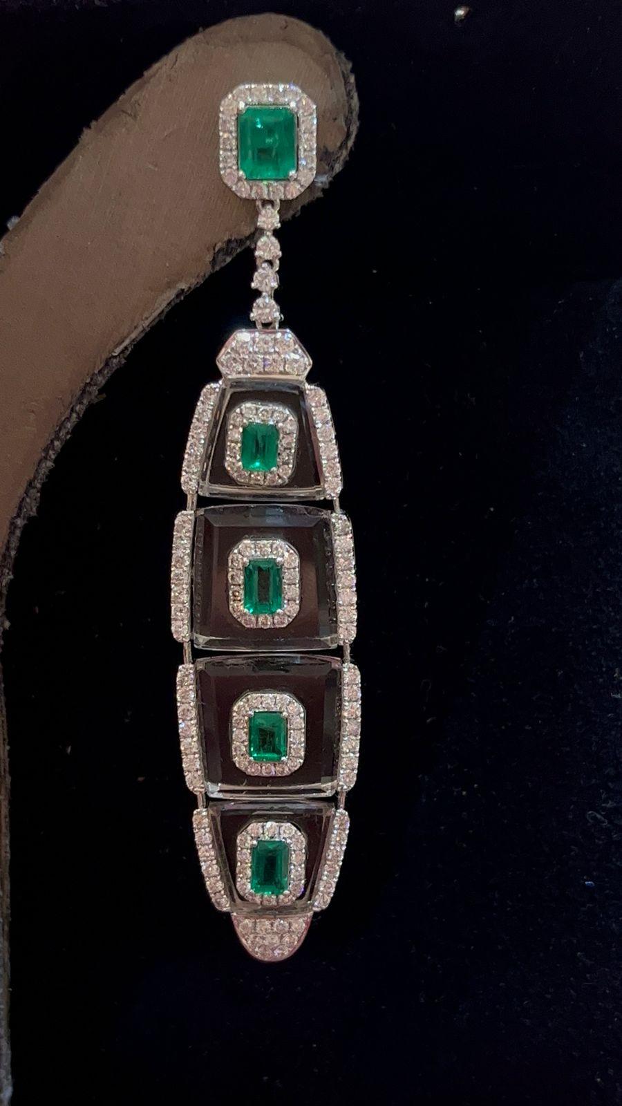 The epitome of elegance and sophistication, these exquisite 18k white gold earrings seamlessly blend the timeless allure of emeralds with the dazzling brilliance of diamonds, creating a harmonious symphony of colour and sparkle. 

Surrounding the