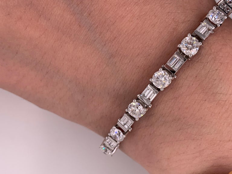 This absolutely elegant and classic bracelet features top quality Round and Emerald cut Baguettes.
The total diamond weight is 11.00 Carats. 
This is a Bar Set Tennis Bracelet. Each diamond individually important.