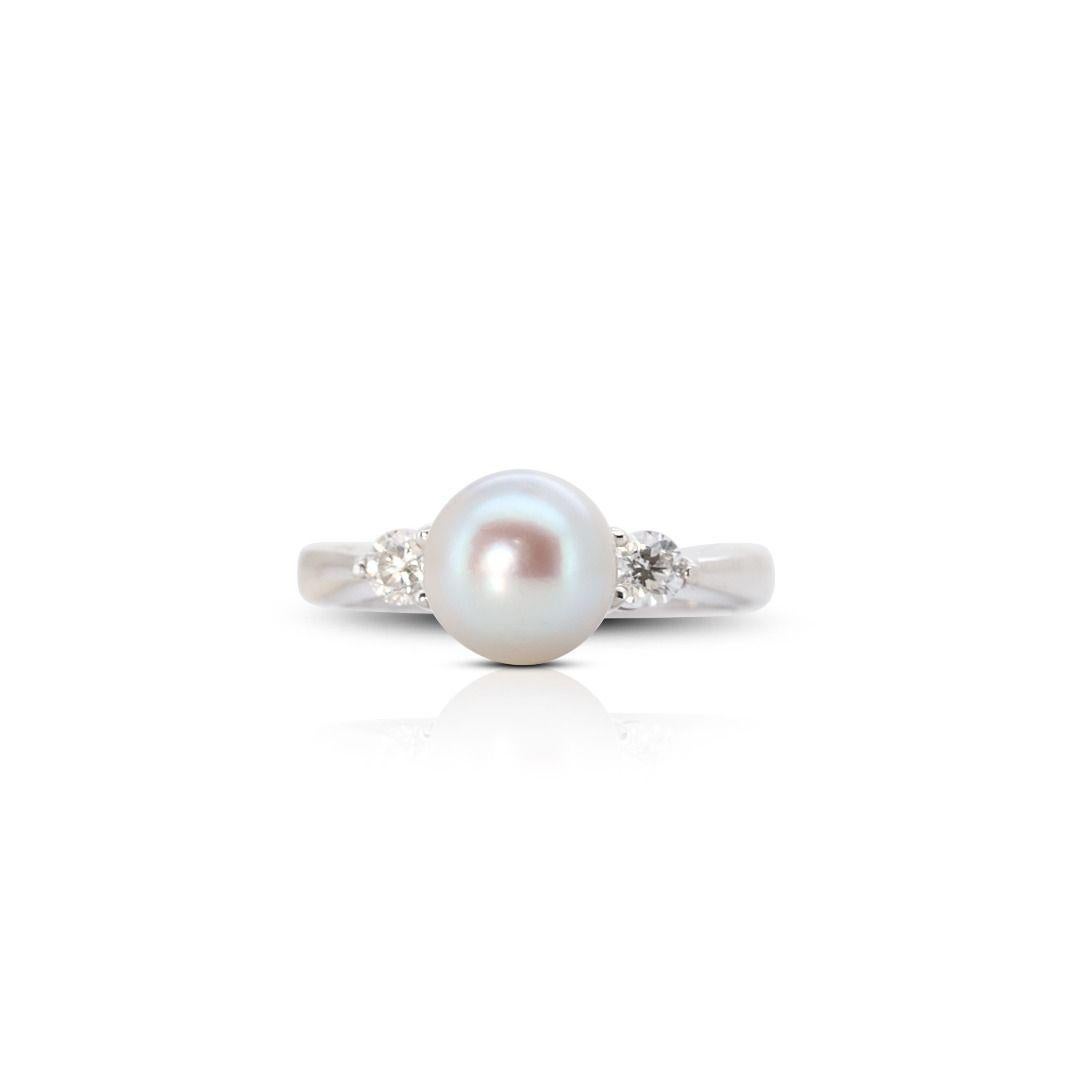 At the heart of the ring lies a lustrous pearl, a symbol of purity and timeless beauty. This pearl, often of superior quality, serves as the centerpiece of the ring, radiating its natural iridescence and soft elegance. It is encircled by a delicate