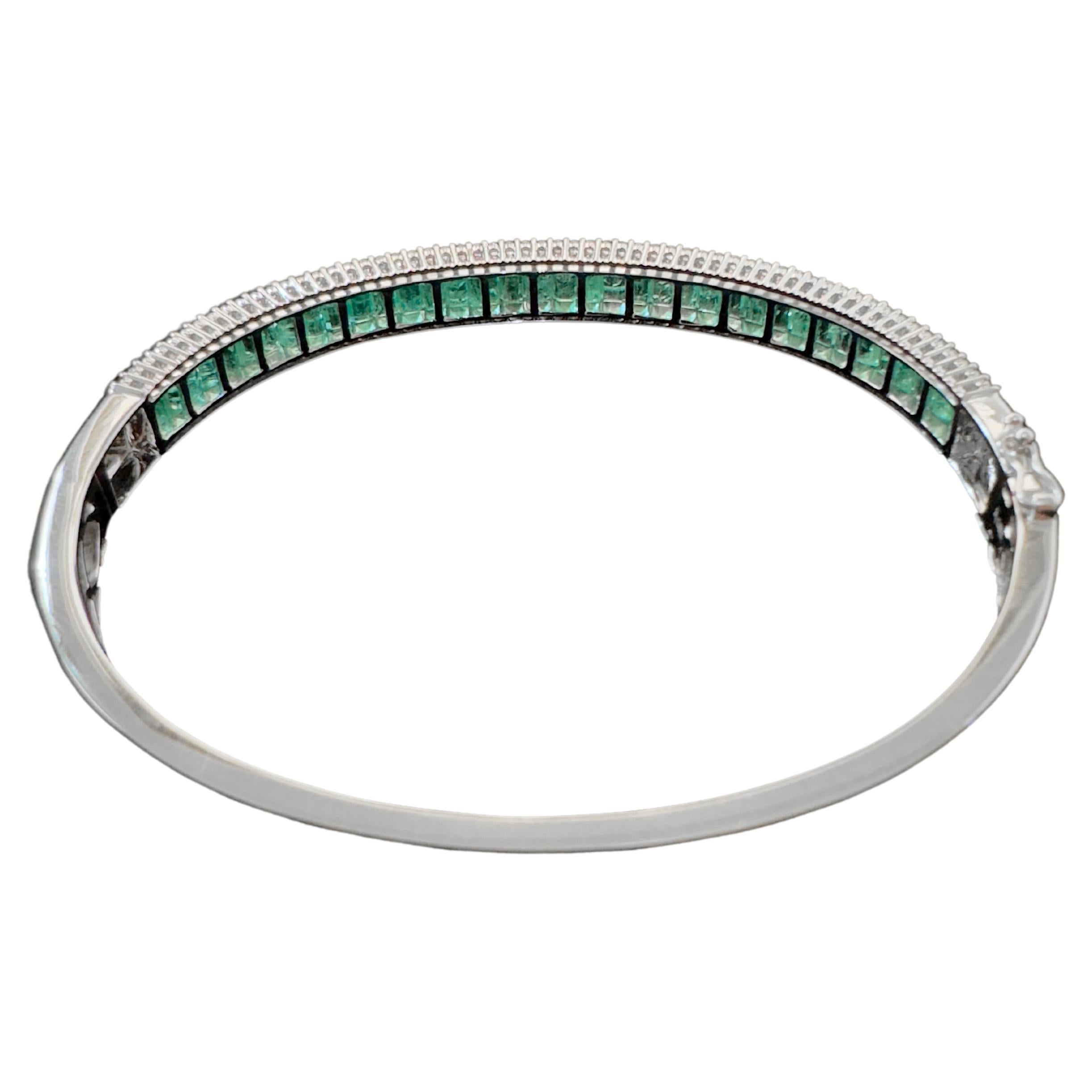 Custom made, this elegant emerald and diamond bangle will be part of your daily stacking arsenal!  The emerald baguettes are carefully channel set while the round brilliant diamonds are prong set on the shoulders to protect the emeralds.  The bangle