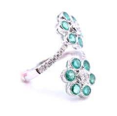 18 Karat White Gold Emerald and Diamond Double Flower Bypass Ring