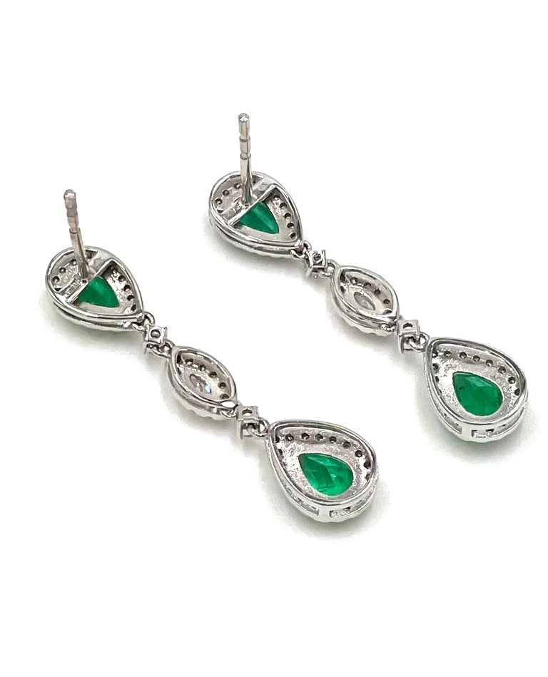 Pair of 18K white gold dangle earrings with 102 round diamonds 0.44 carat, 2 marquis shape diamonds 0.15 carat and 4 pear shape emeralds 1.86 carats.

* Push back posts. Backings included.
* Diamonds are H/I color, SI clarity.