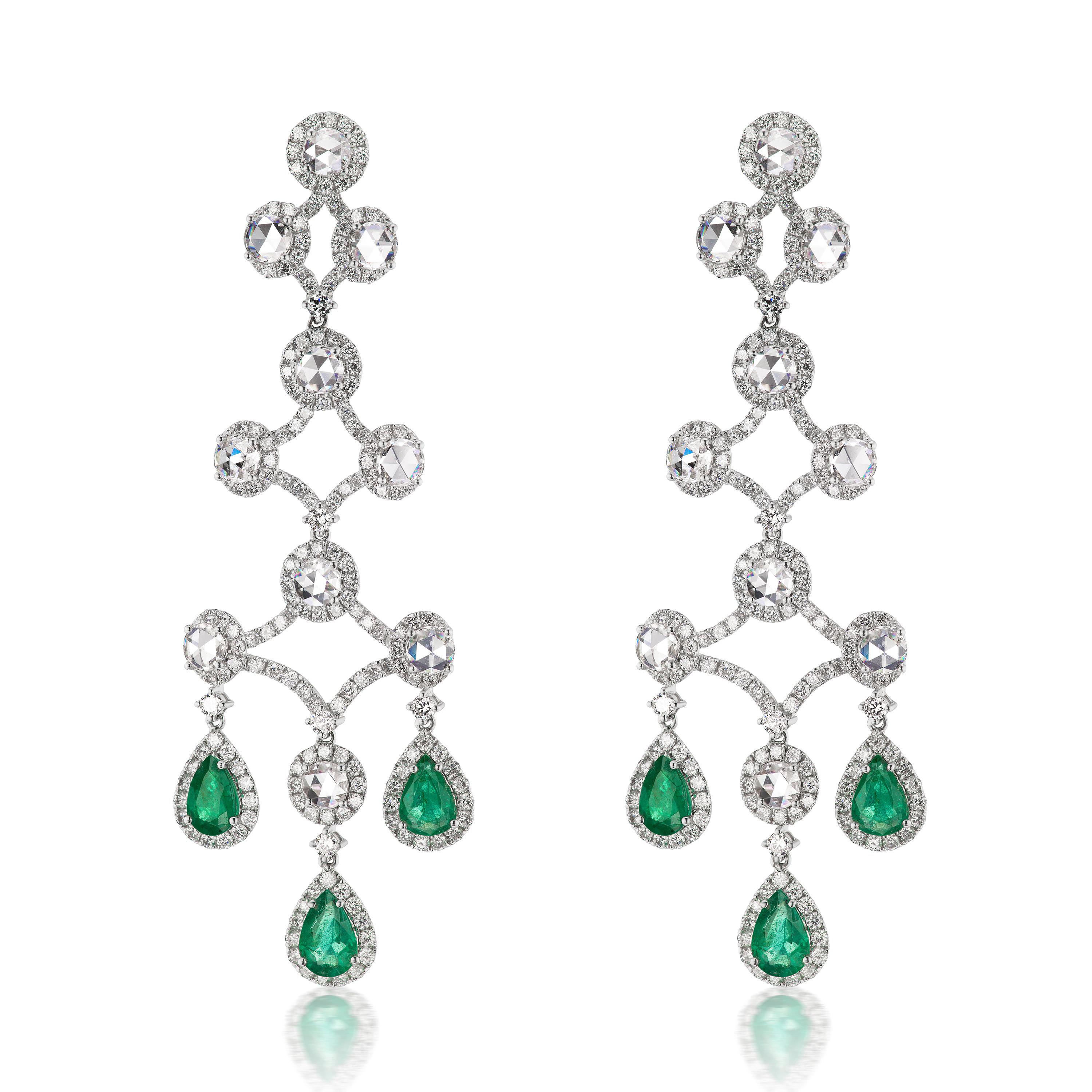 Promising you a scintillating look, these earrings are designed by master craftsmen in 18K White Gold. Displaying a chandelier pattern, this pair is set with 8.38 Cts diamonds and 3.85 Cts pear-shaped Emeralds dropping down at the bottom. These