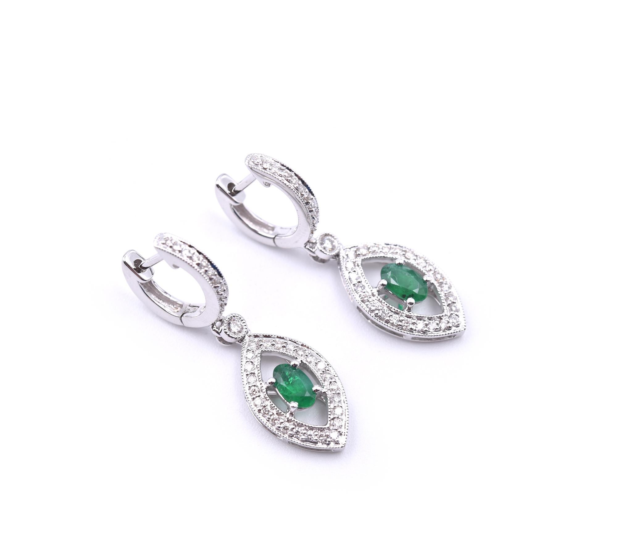 Designer: custom design
Material: 18k white gold
Emeralds: 2 oval cut = 0.60cttw
Diamonds: 72 round brilliant cuts = 0.50cttw
Color: G-H
Clarity: VS
Dimensions: earrings are 8.65mm x 28.5mm
Fastenings: snap closure
Weight: 4.61 grams	

