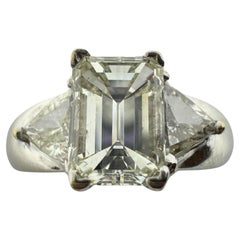 18K White Gold Emerald and Trillion Cut Diamond Three Stone Ring