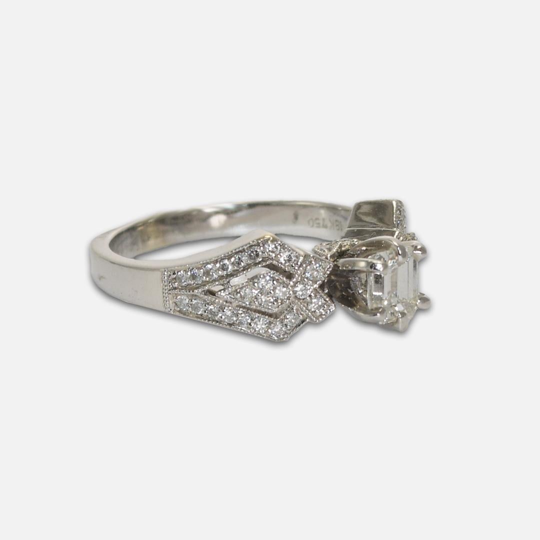 18k white gold Diamond engagement ring.
Stamped 18k, 750, and weighs 5.5 grams.
The center diamond is an emerald cut, .50 carats, g color, vs2 clarity, very good cut.
On the sides are small round brilliant cuts, .50 total carats, g color, vs to si