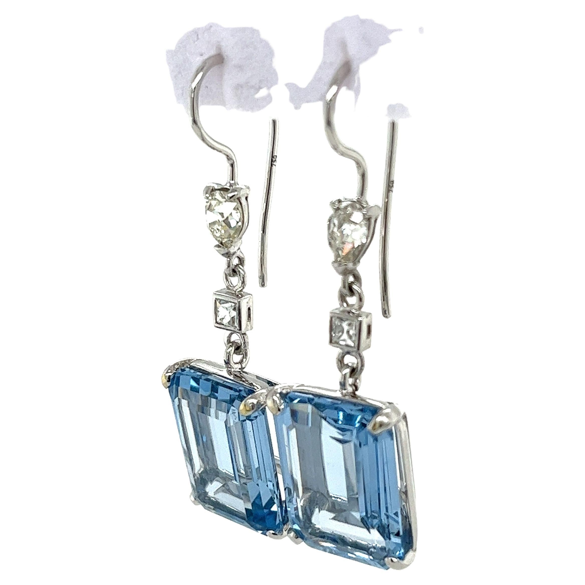 Vibrant and lustrous emerald-cut lab grown spinel drop earrings of over 31 carats stationed on a 4 prong 18k white gold setting. Featuring a princess cut and pear shape old-cut diamonds with an open culet. Offering a gorgeous marriage between